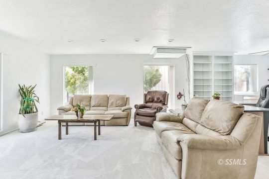 712 East Kendall Avenue Ridgecrest, CA 93555 - Photo 16 of 50 a living room with furniture and a large window