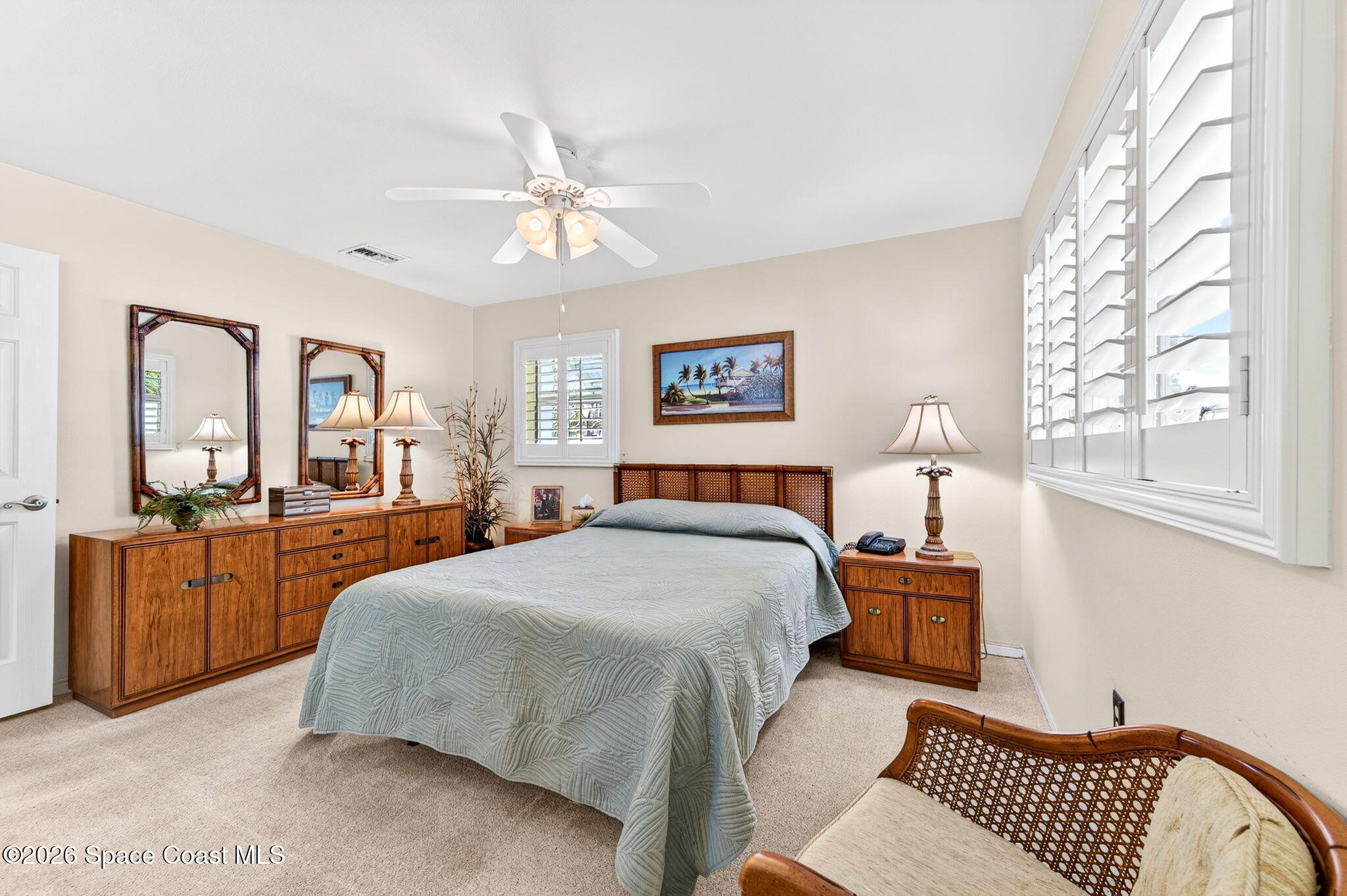 935 Samar Road Cocoa Beach, FL 32931 - Photo 11 of 22 a spacious bedroom with a large bed and a chandelier