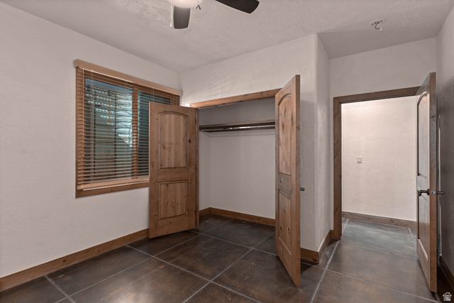 2464 East Granite Way St. George, UT 84790 - Photo 98 of 106 Unfurnished second bedroom featuring ceiling fan, a closet, a textured wall, and a textured ceiling