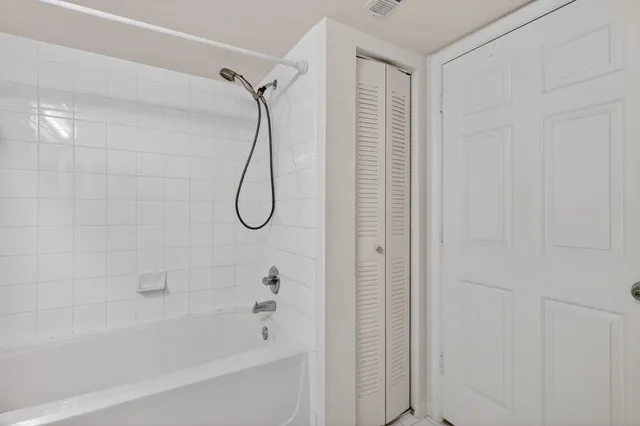 a bathroom with a bath tub with a shower