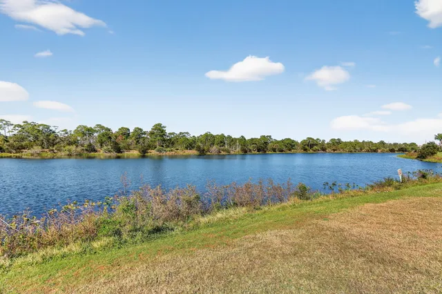 a view of a lake with houses in the back