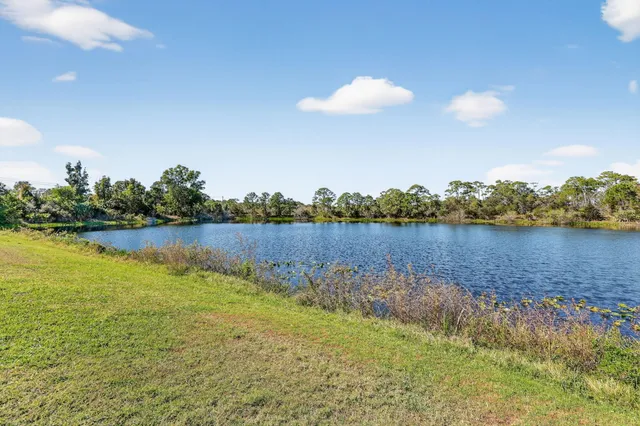 a view of a lake with houses in the back