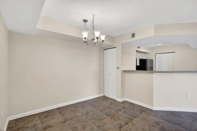 wooden floor in an empty room with a kitchen
