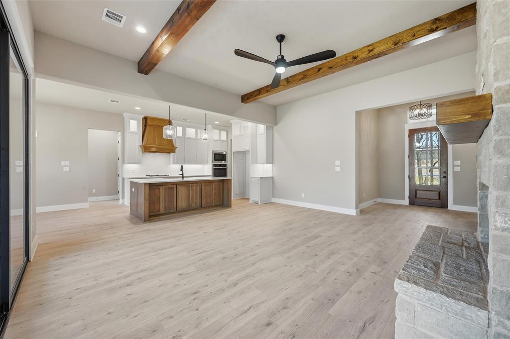 1053 Llano Way Poolville, TX 76487 - Photo 8 of 40 a large white kitchen with a stove top oven a sink and dishwasher