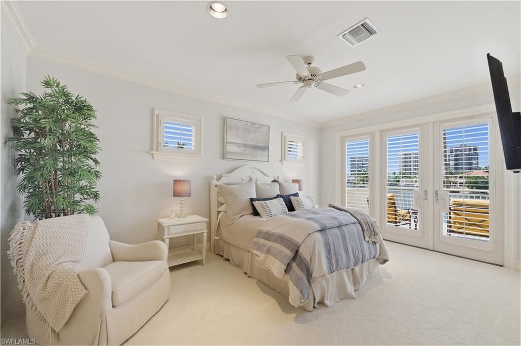 361 Pirates Bight Naples, FL 34103 - Photo 33 of 45 a spacious bedroom with a bed and a couch