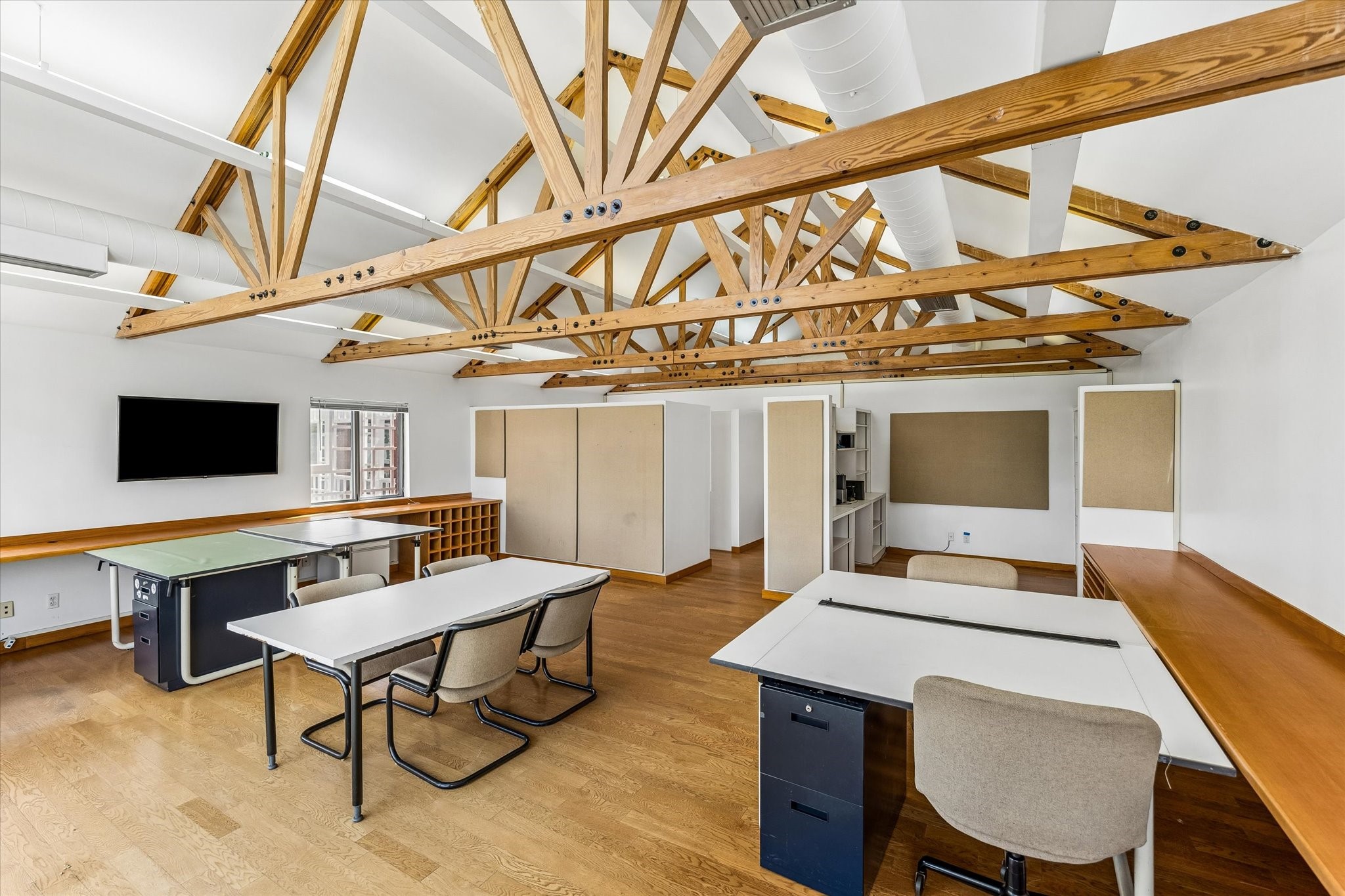 2402 Commonwealth Street Houston, TX 77006 - Photo 9 of 45 a workspace with furniture and wooden floor