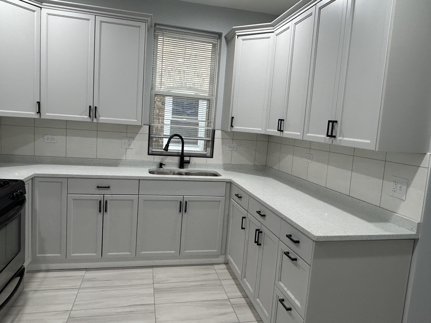 7940 South Carpenter Street, Unit 2 Chicago, IL 60620 - Photo 25 of 34 a kitchen with white cabinets and sink