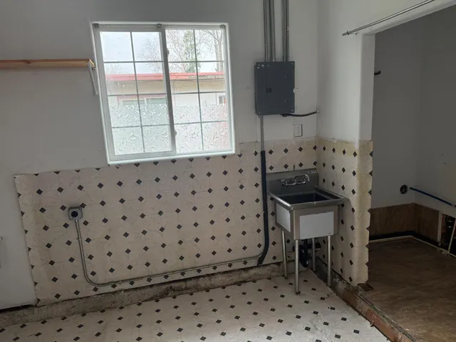 a bathroom with a sink a toilet and a shower