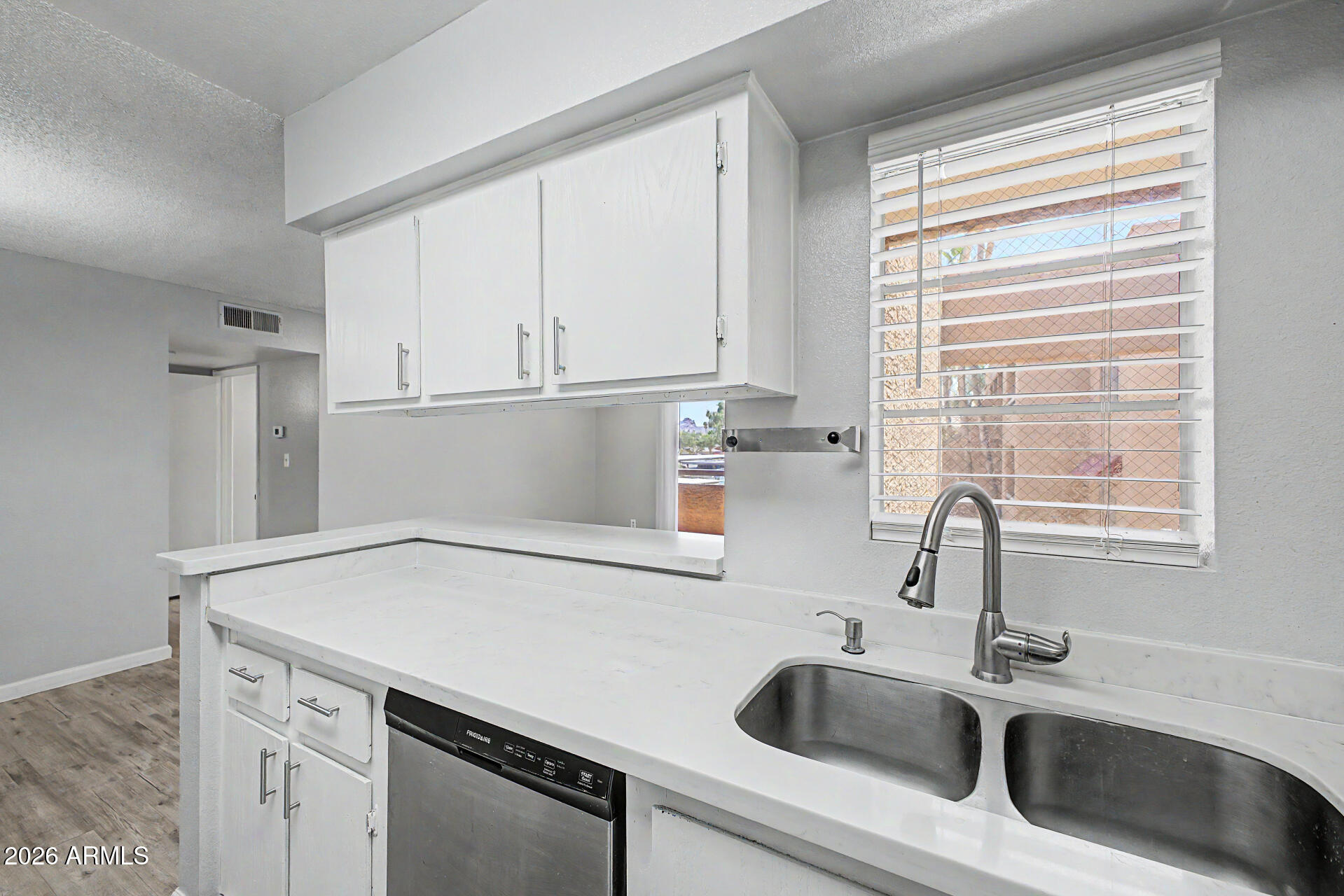 2625 East Indian School Road, Unit 227 Phoenix, AZ 85016 - Photo 5 of 31 a kitchen with a sink cabinets and window