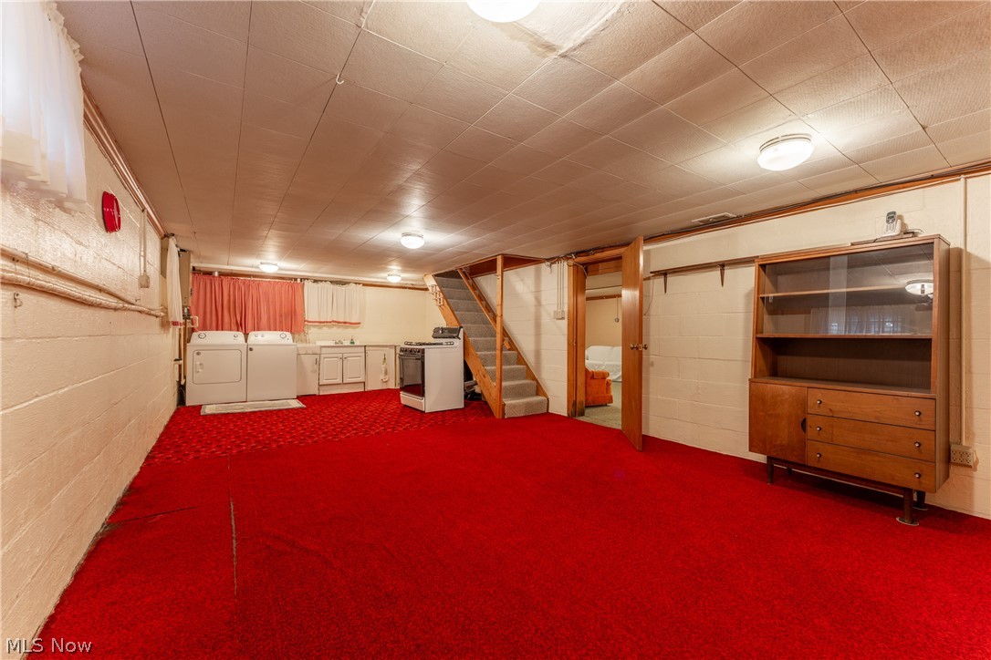 4833 Angling Road Wooster, OH 44691 - Photo 34 of 49 Basement with dark carpet and washer and clothes dryer