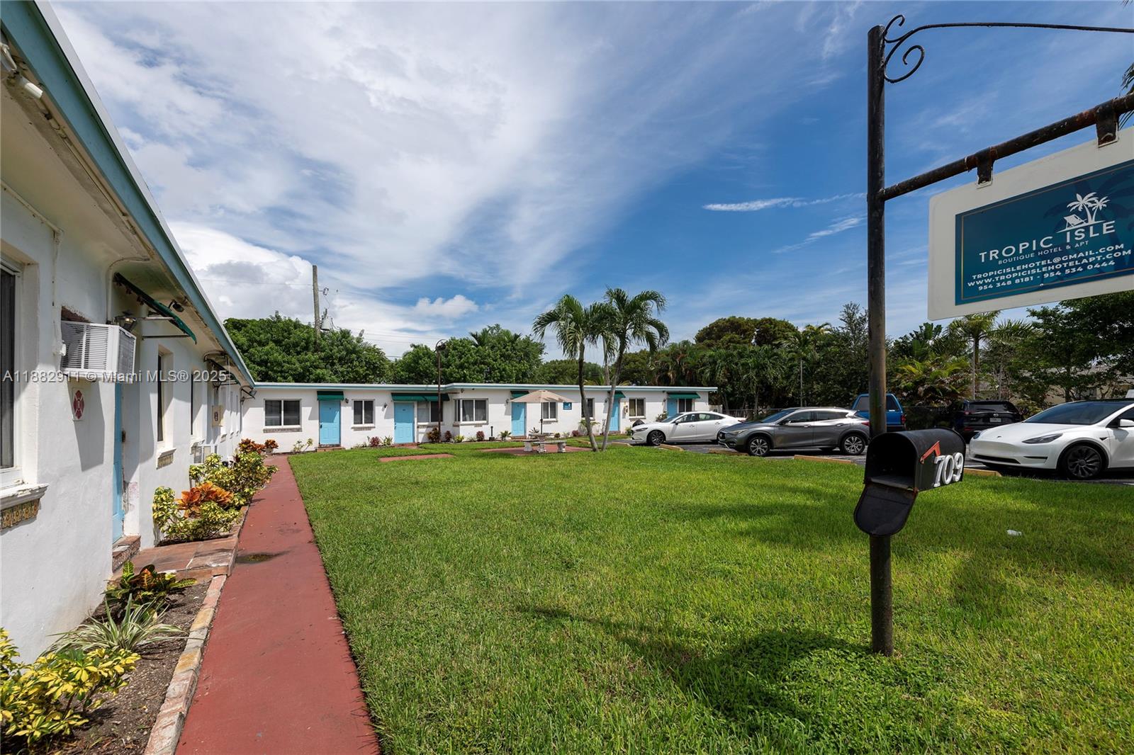 709 Northeast 2nd Court, Unit 19 Hallandale Beach, FL 33009 - Photo 12 of 12 a front view of a house with garden