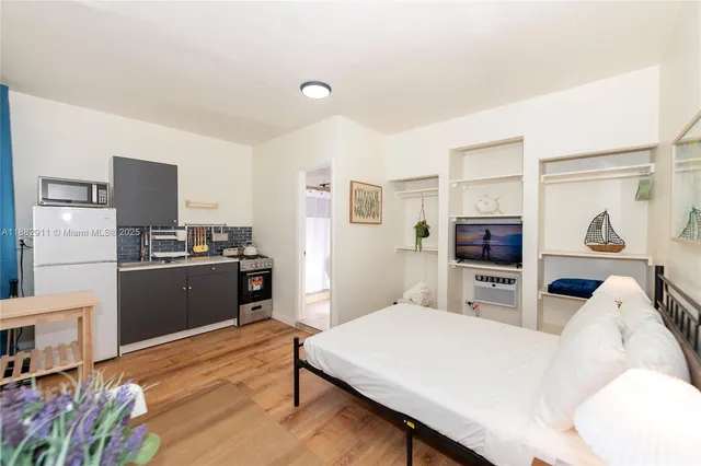 a kitchen with stainless steel appliances a refrigerator and a stove top oven