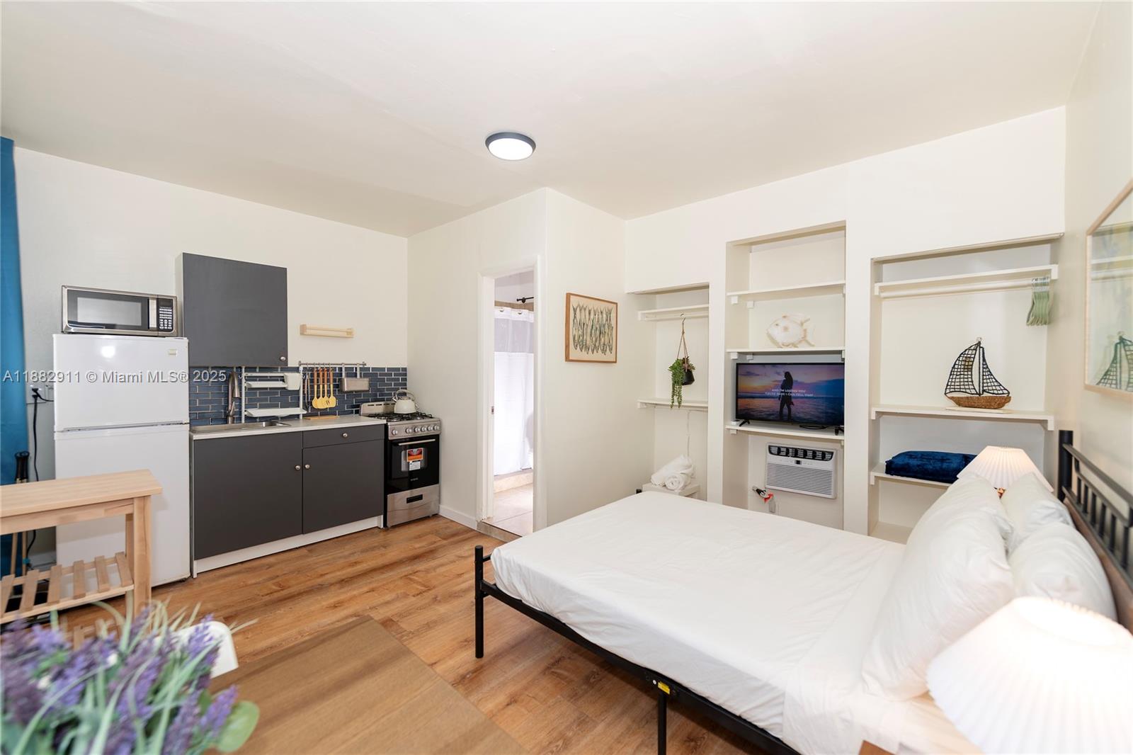 709 Northeast 2nd Court, Unit 19 Hallandale Beach, FL 33009 - Photo 3 of 12 a kitchen with stainless steel appliances a refrigerator and a stove top oven