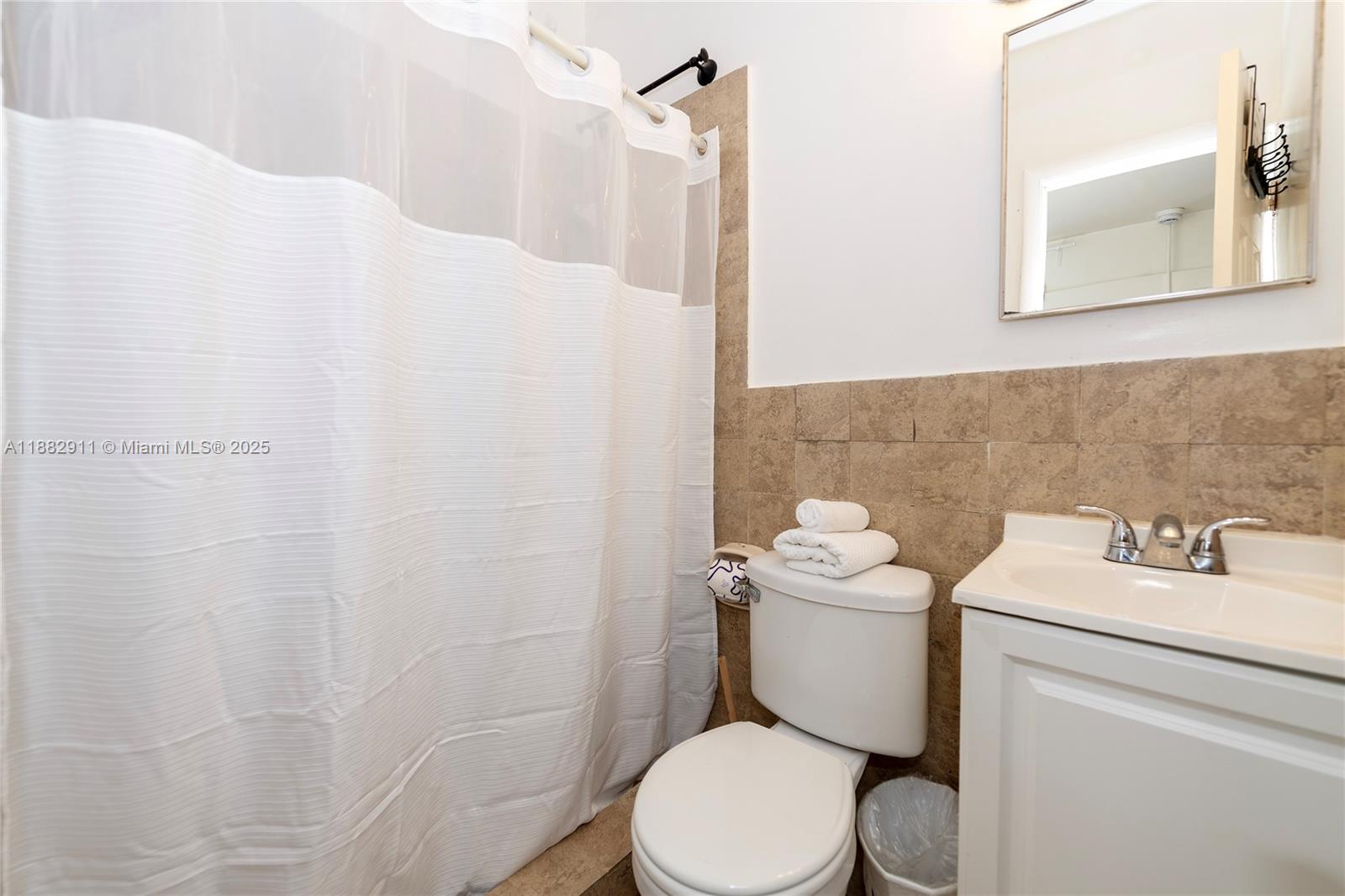 709 Northeast 2nd Court, Unit 19 Hallandale Beach, FL 33009 - Photo 5 of 12 a white toilet sitting next to a bathroom sink