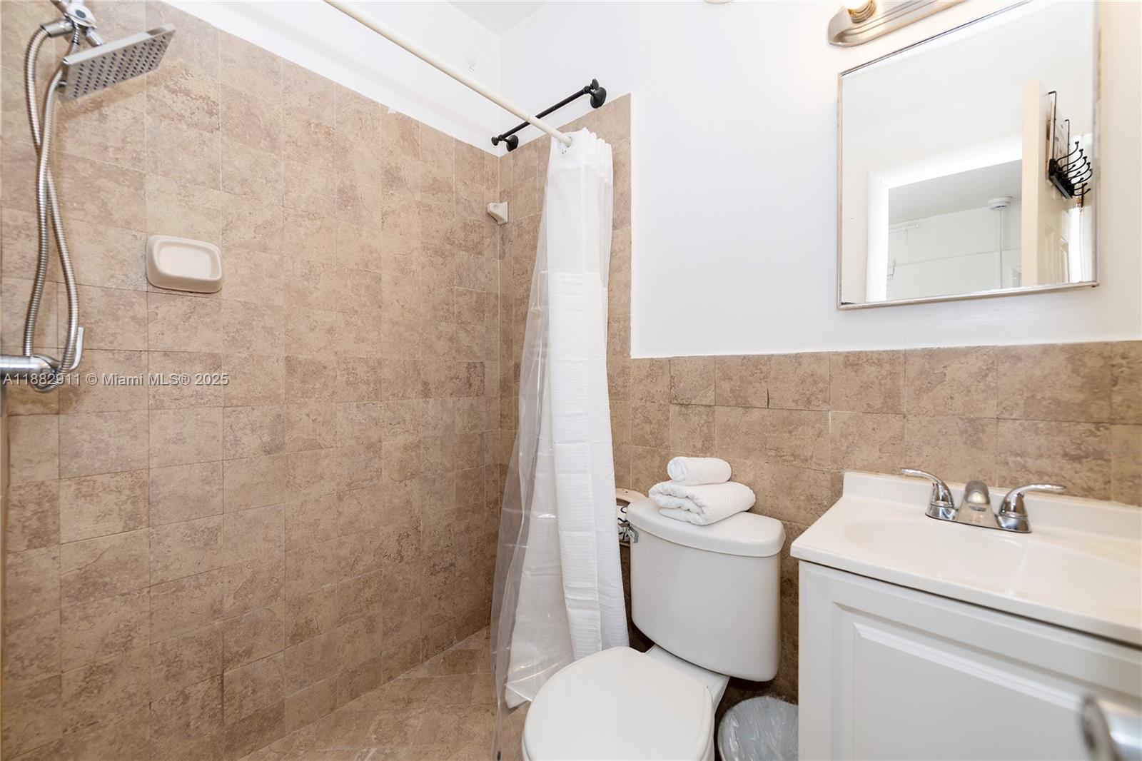 709 Northeast 2nd Court, Unit 19 Hallandale Beach, FL 33009 - Photo 6 of 12 a bathroom with a sink mirror toilet and shower