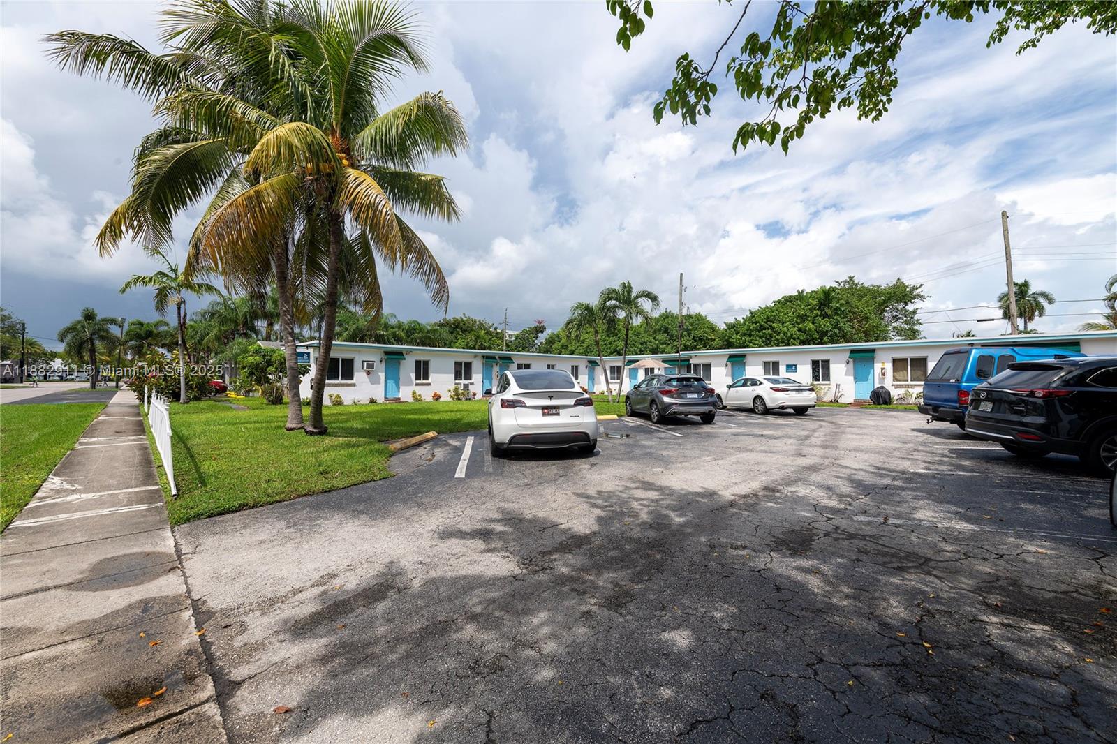 709 Northeast 2nd Court, Unit 19 Hallandale Beach, FL 33009 - Photo 9 of 12 a view of a street with cars on both side of the road