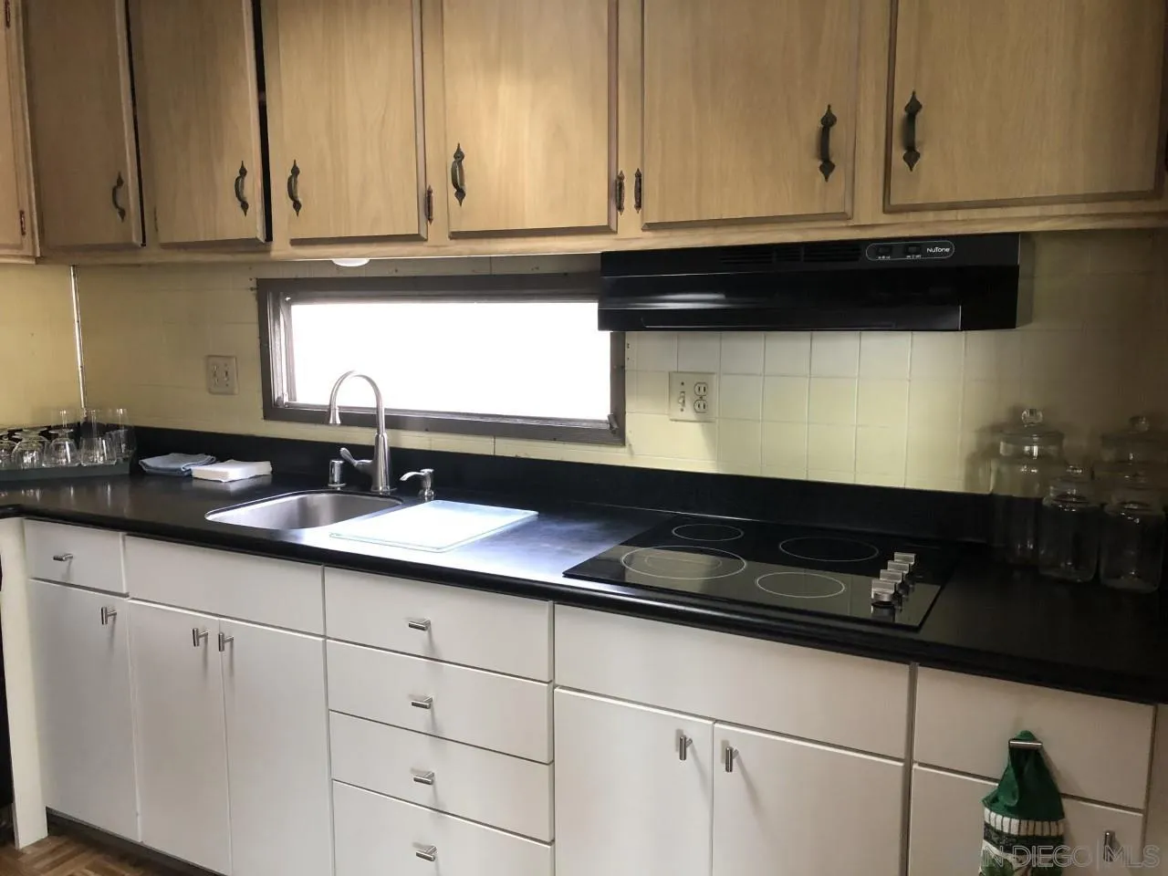 9459 Mission Gorge Road, Unit 18 Santee, CA 92071 - Photo 3 of 13 a kitchen with granite countertop white cabinets and a sink