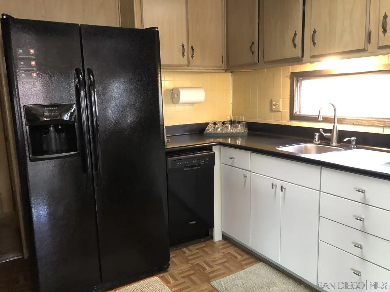 9459 Mission Gorge Road, Unit 18 Santee, CA 92071 - Photo 4 of 13 a kitchen with granite countertop a refrigerator and a sink