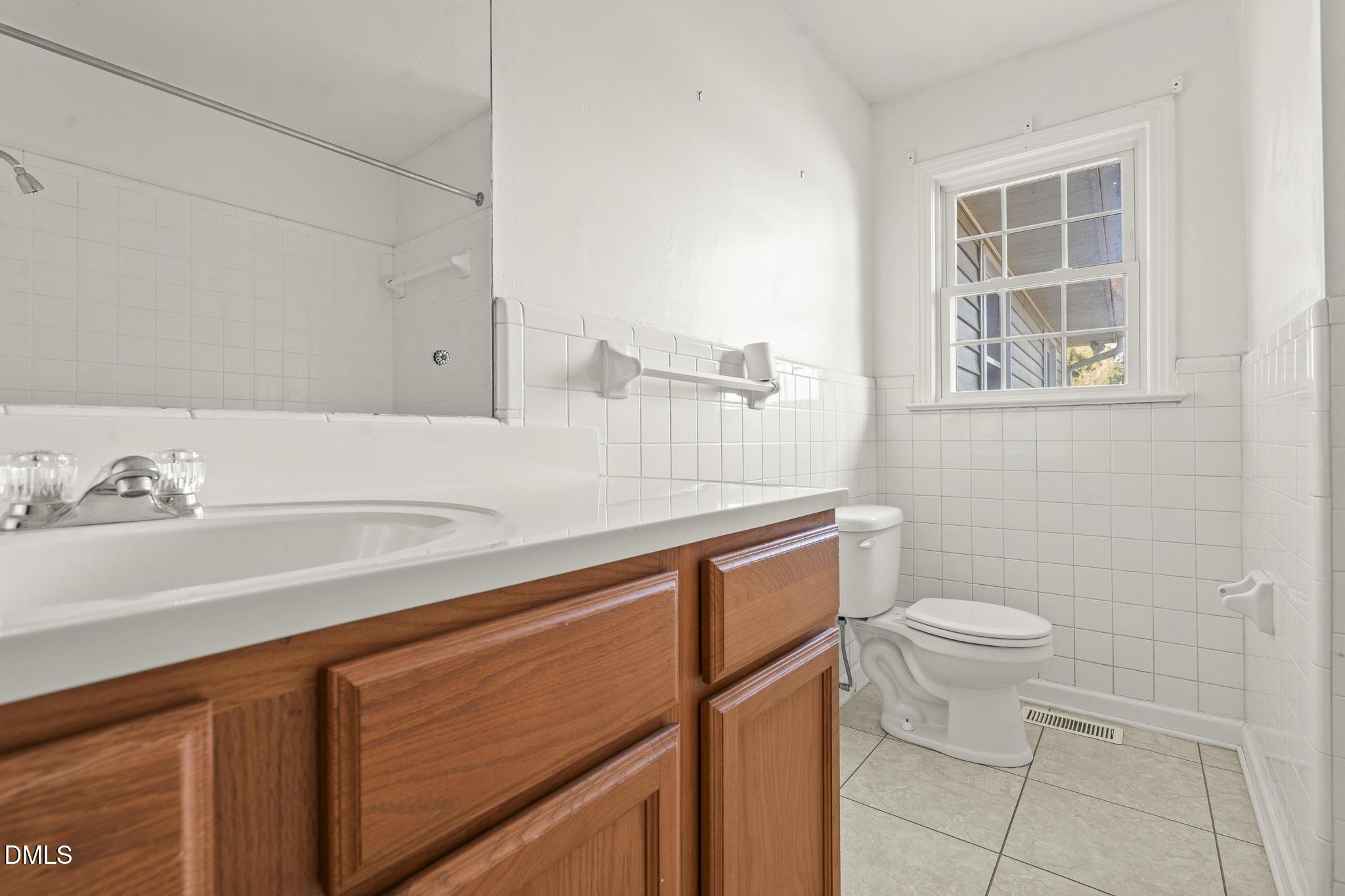 2400 Carbonton Road Sanford, NC 27330 - Photo 15 of 26 a bathroom with a sink a toilet and a mirror