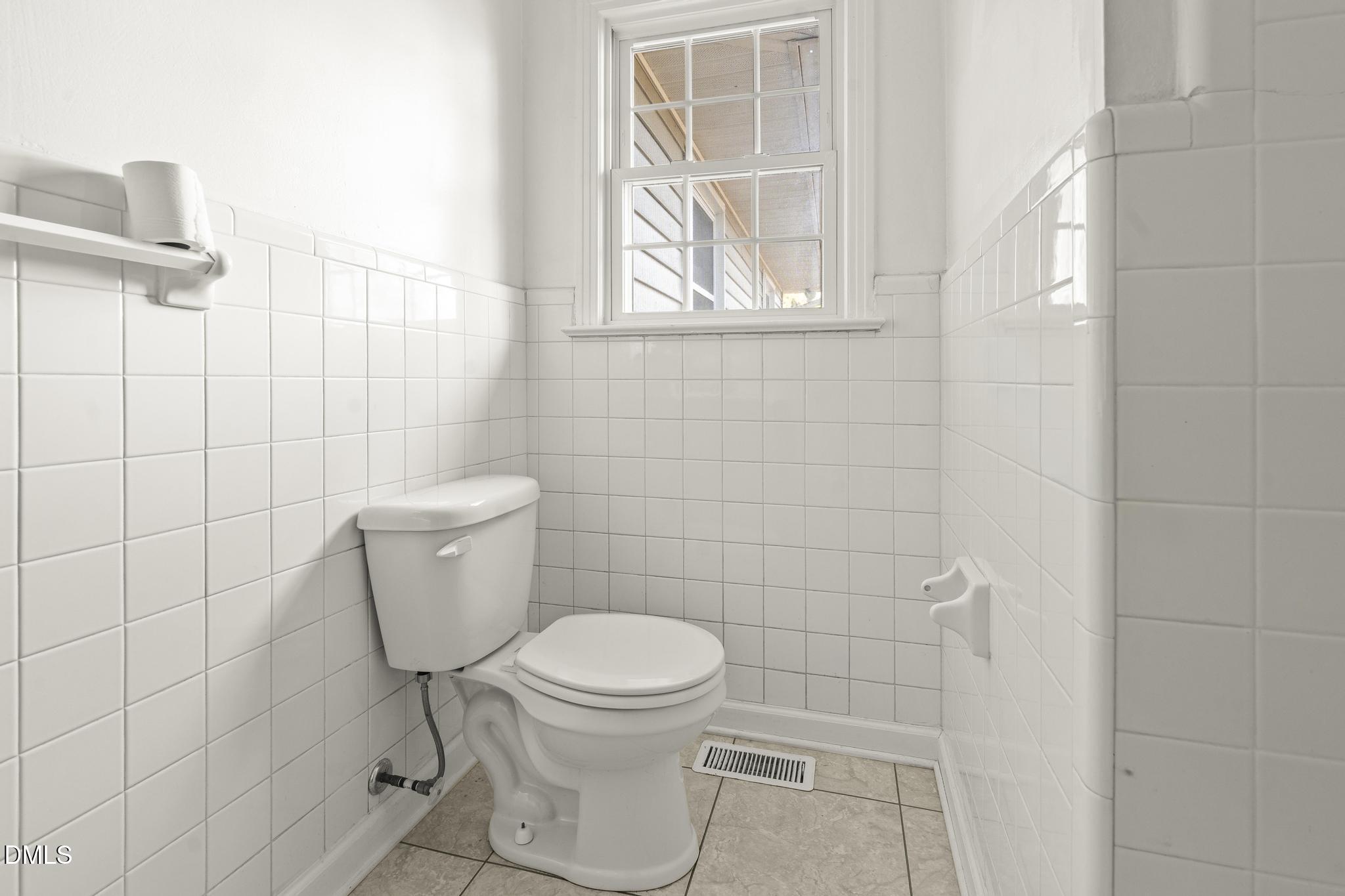 2400 Carbonton Road Sanford, NC 27330 - Photo 16 of 26 a white toilet sitting next to a bathroom sink