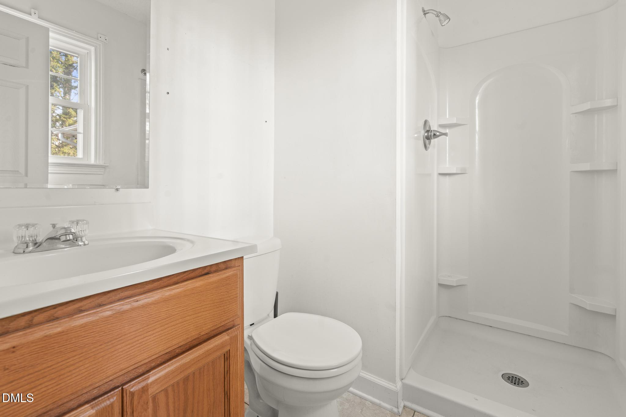 2400 Carbonton Road Sanford, NC 27330 - Photo 25 of 26 a bathroom with a sink a toilet and shower
