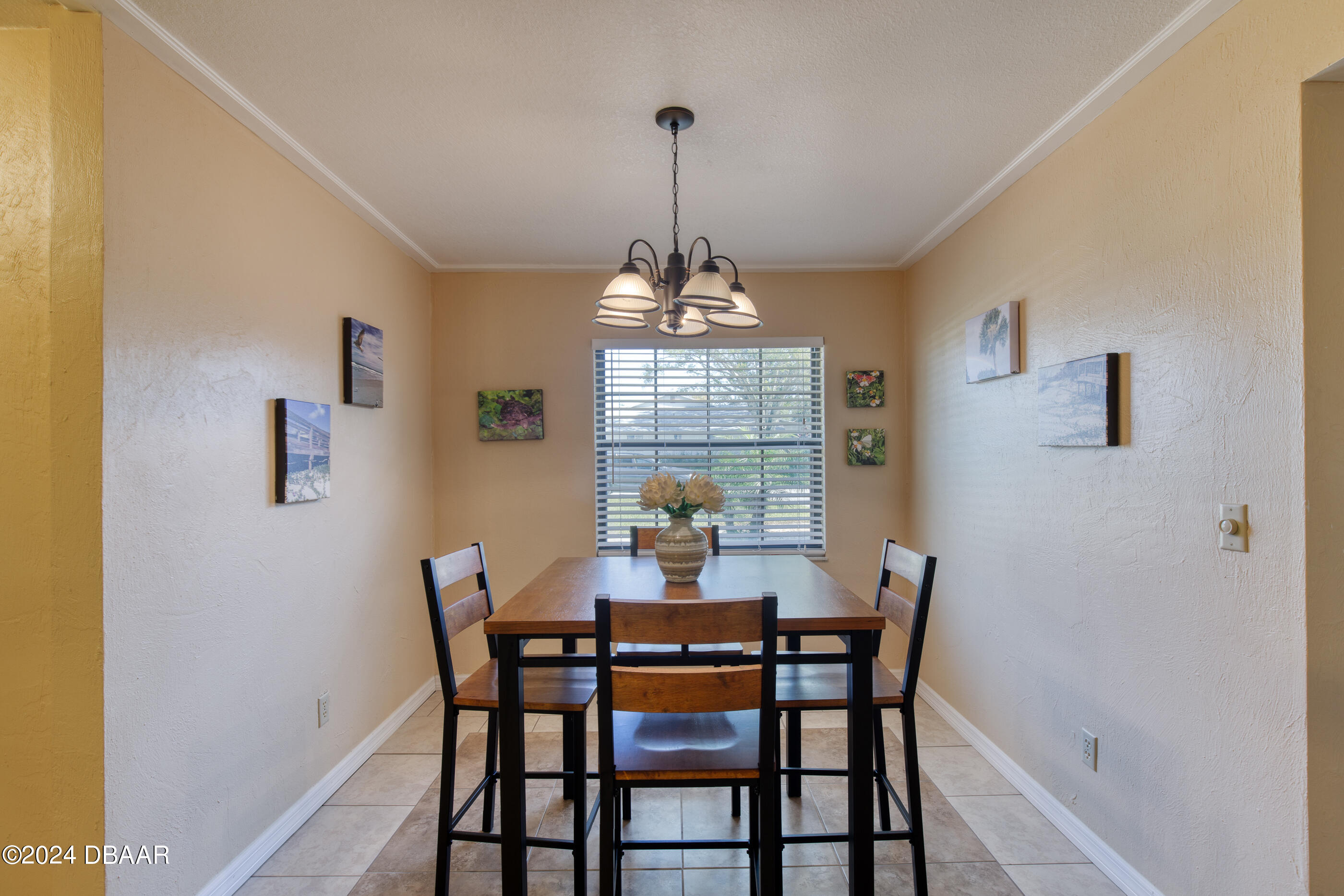 2304 Yule Tree Drive Edgewater, FL 32141 - Photo 11 of 34 a dining room with furniture a chandelier and window