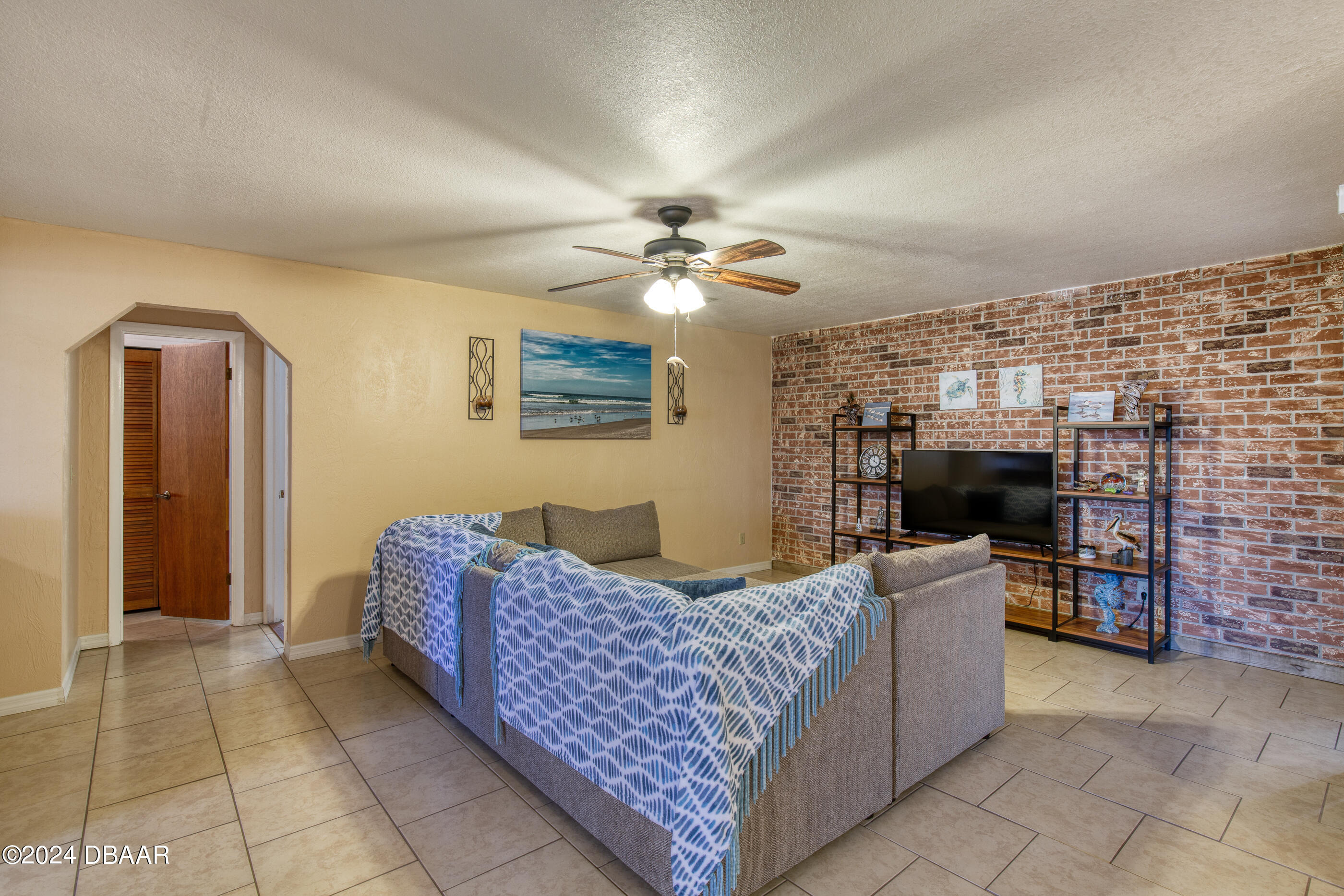2304 Yule Tree Drive Edgewater, FL 32141 - Photo 13 of 34 a living room with furniture and a fireplace
