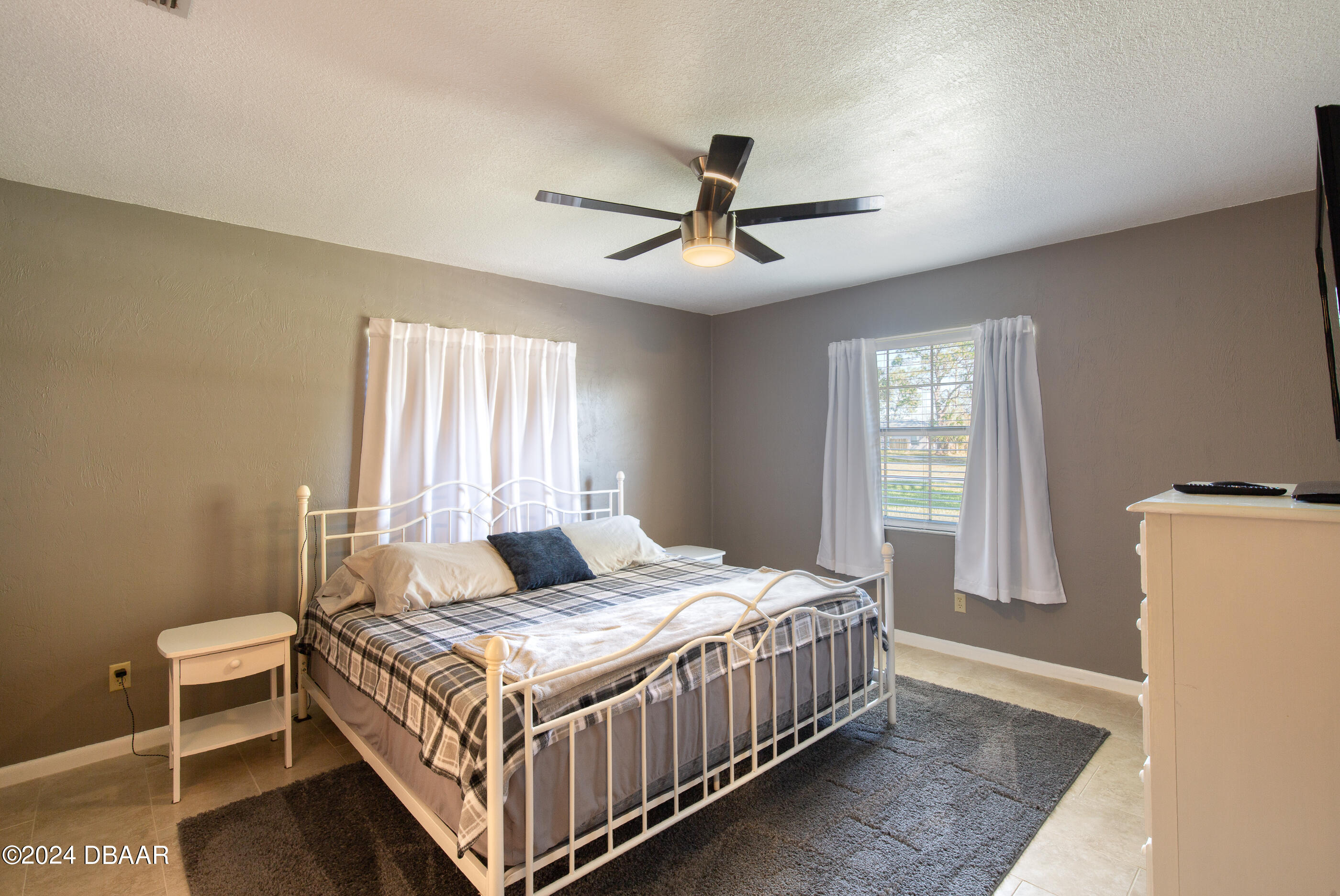 2304 Yule Tree Drive Edgewater, FL 32141 - Photo 16 of 34 a bedroom with a bed and window