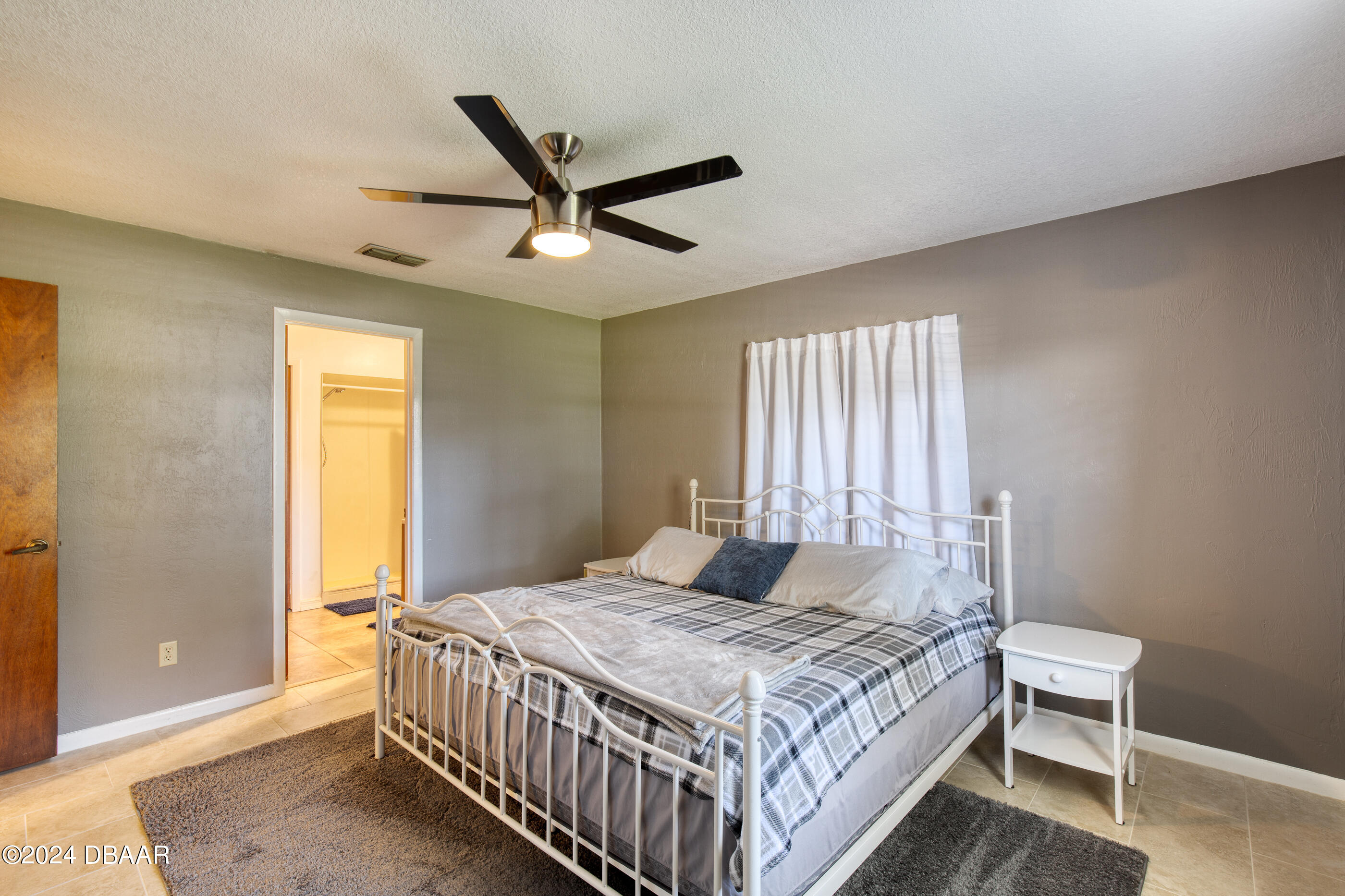 2304 Yule Tree Drive Edgewater, FL 32141 - Photo 17 of 34 a bedroom with a bed and a window