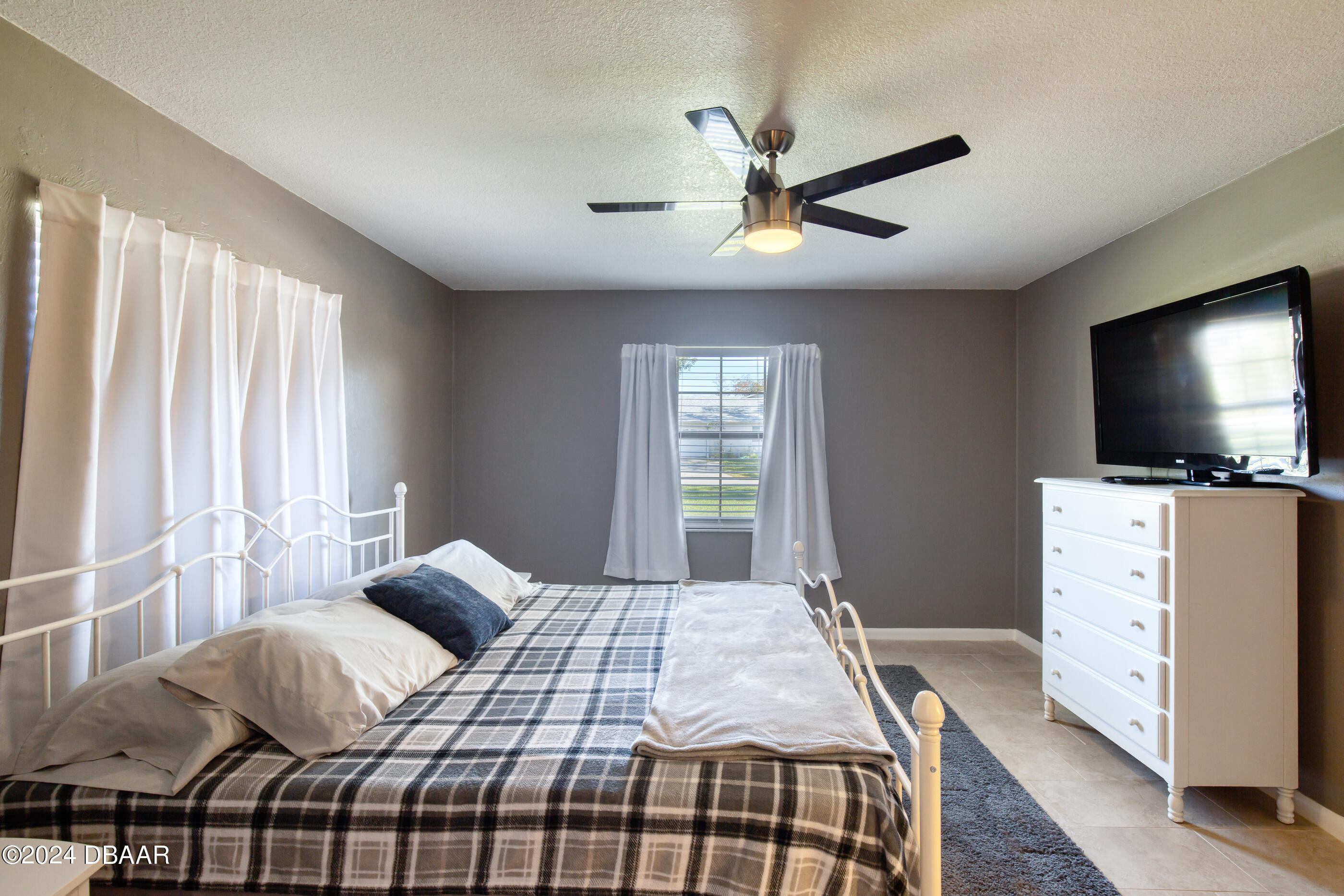 2304 Yule Tree Drive Edgewater, FL 32141 - Photo 18 of 34 a bedroom with a bed and flat screen tv