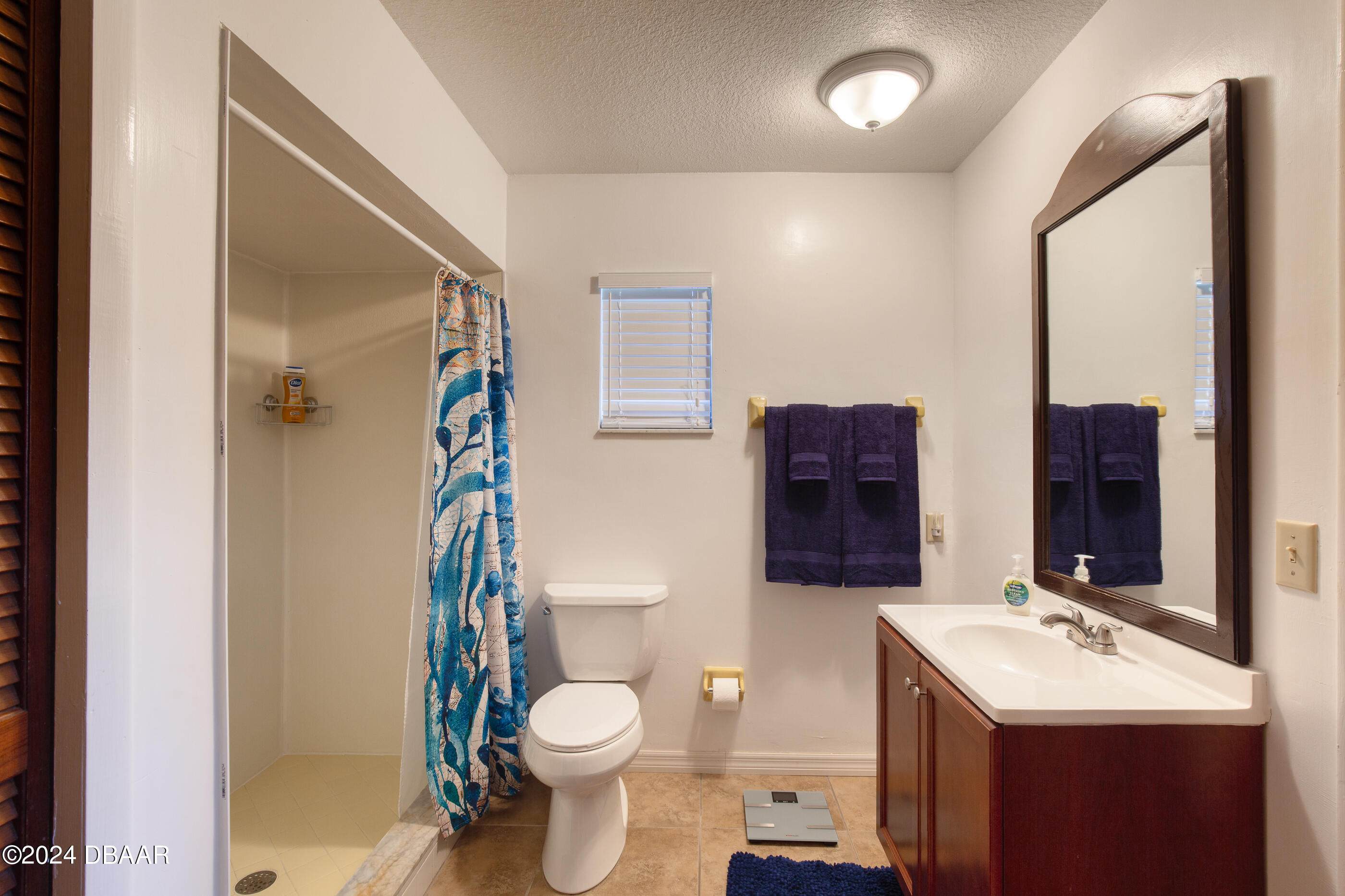 2304 Yule Tree Drive Edgewater, FL 32141 - Photo 19 of 34 a bathroom with a toilet sink and mirror