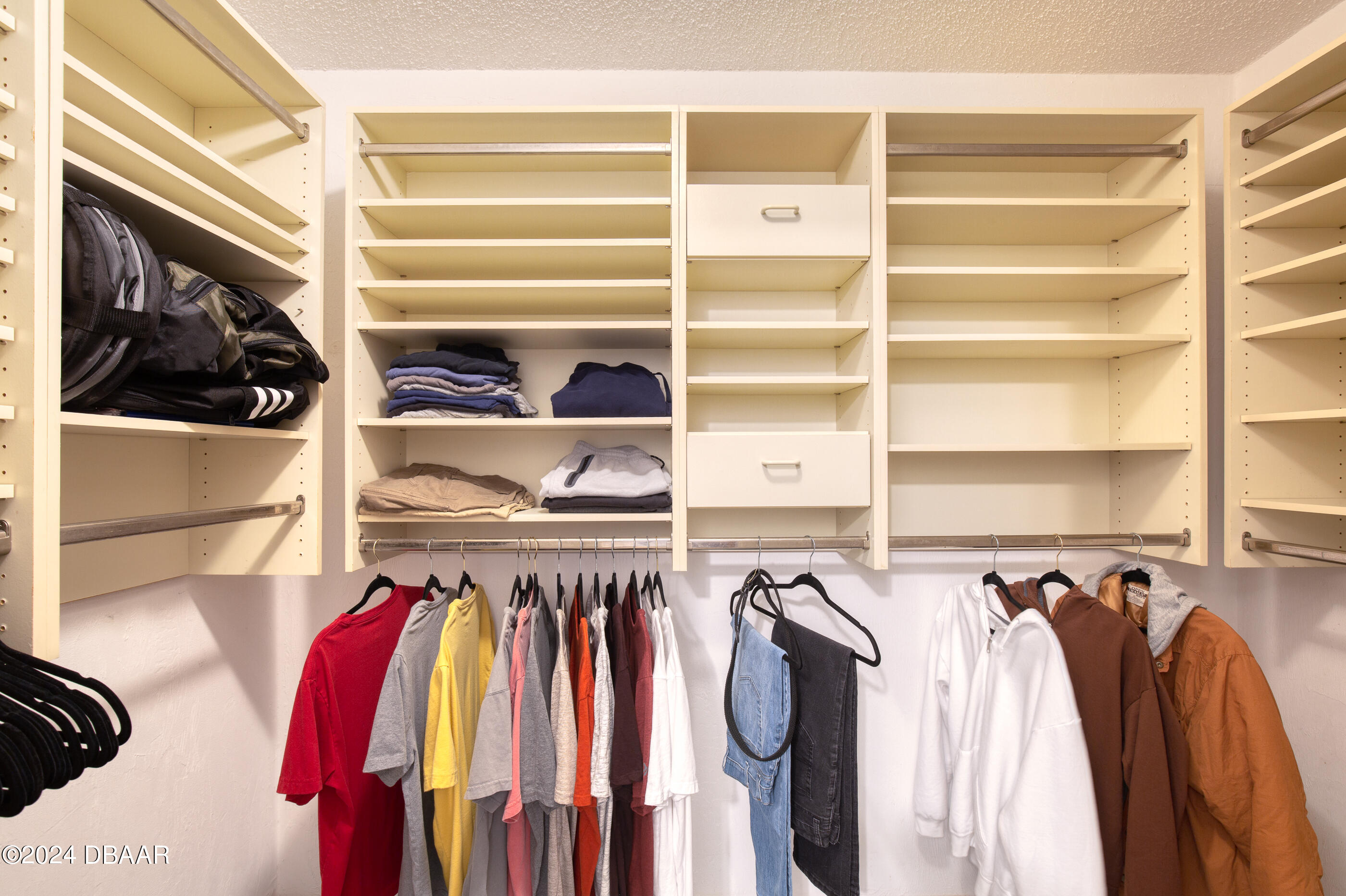 2304 Yule Tree Drive Edgewater, FL 32141 - Photo 20 of 34 a view of walk in closet with clothes and shoes