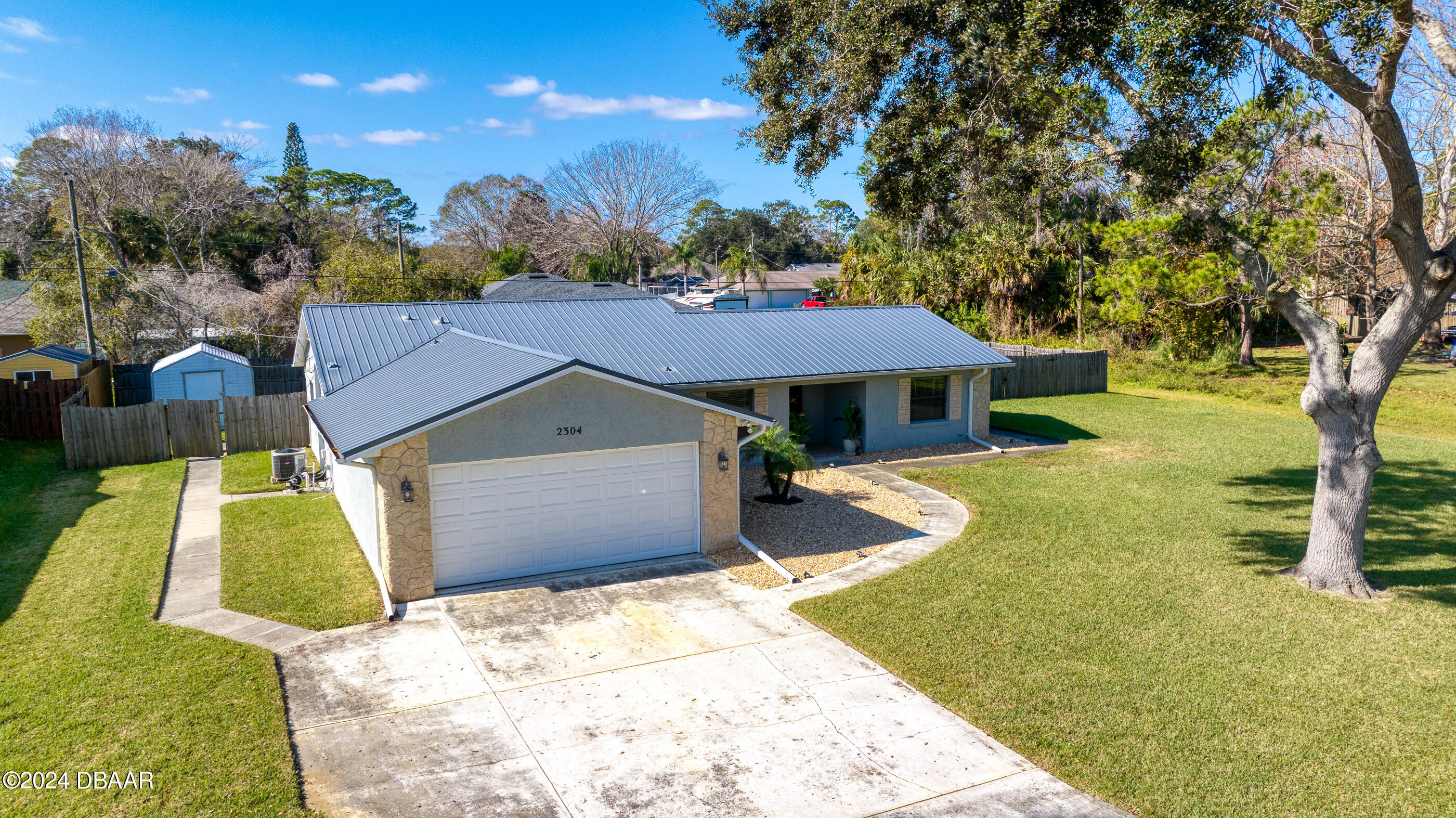 2304 Yule Tree Drive Edgewater, FL 32141 - Photo 2 of 34 a front view of a house with a yard