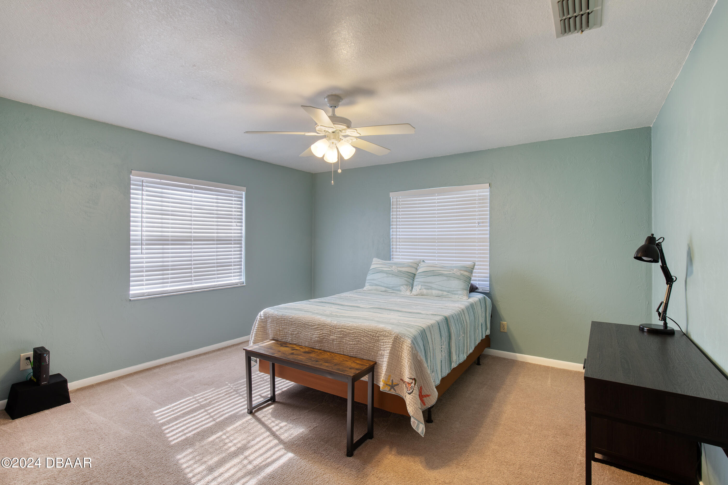 2304 Yule Tree Drive Edgewater, FL 32141 - Photo 21 of 34 a bedroom with a bed desk and a window