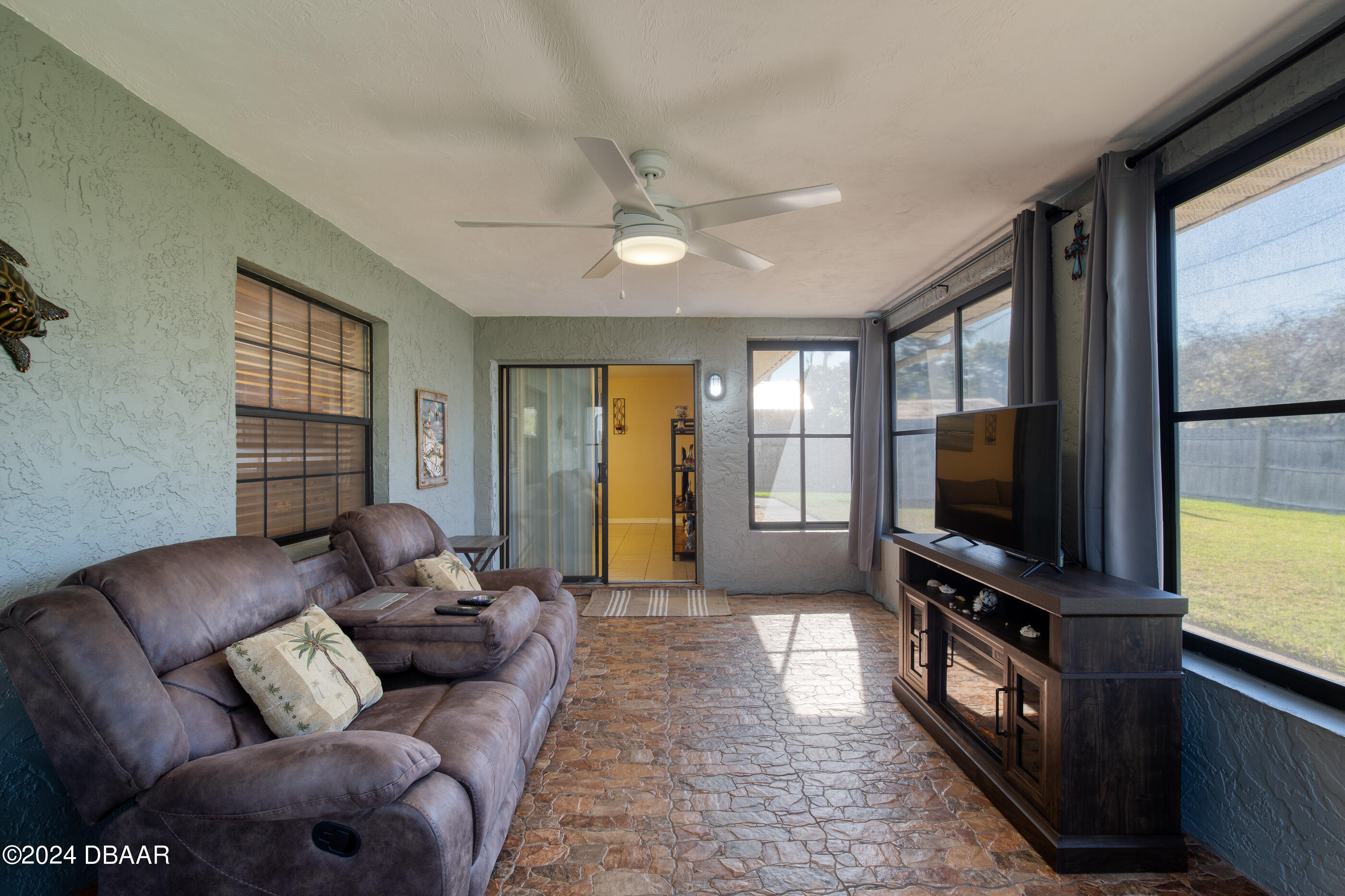 2304 Yule Tree Drive Edgewater, FL 32141 - Photo 27 of 34 a living room with furniture and a flat screen tv