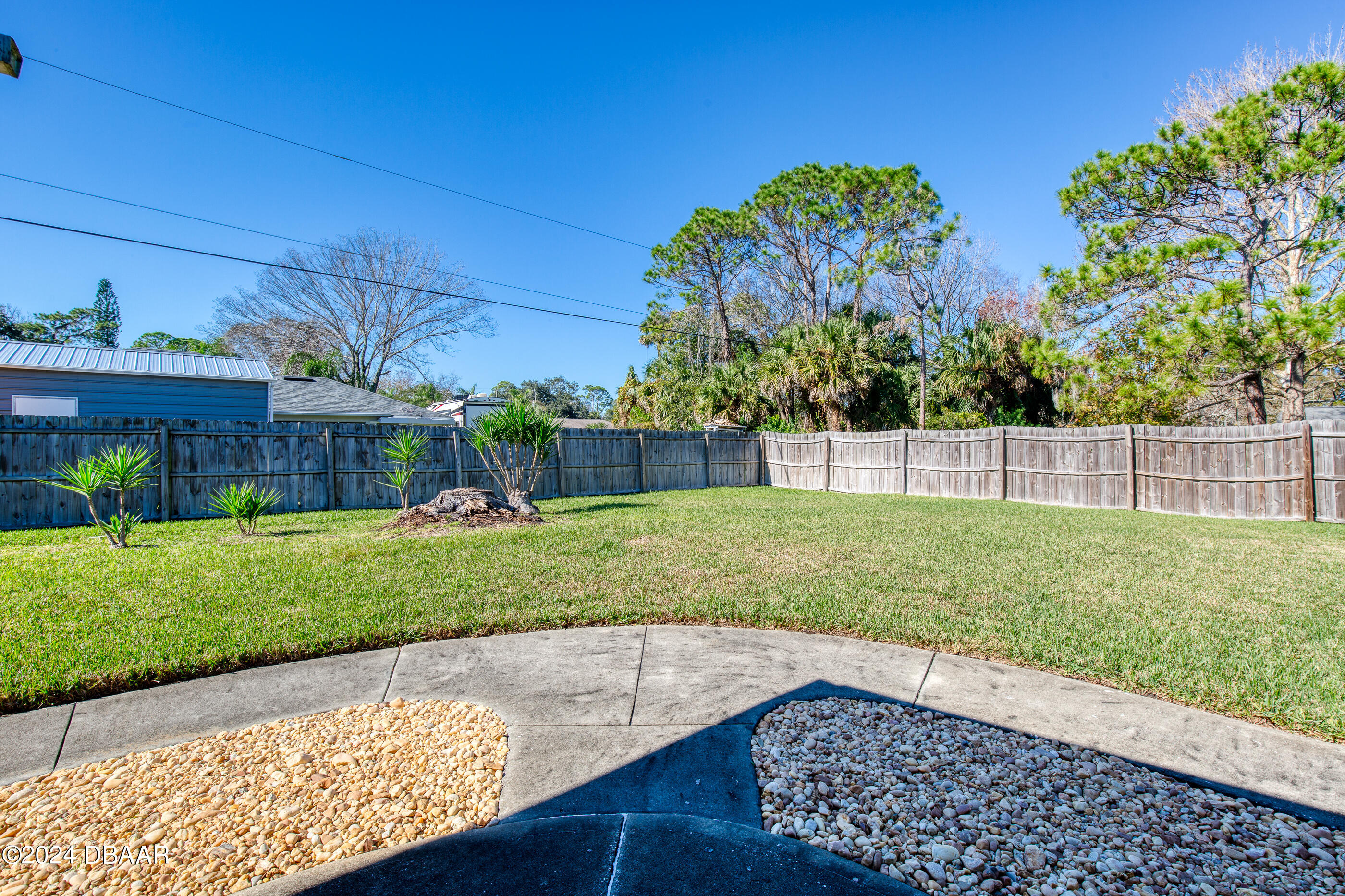 2304 Yule Tree Drive Edgewater, FL 32141 - Photo 28 of 34 a view of a backyard with plants and a garden