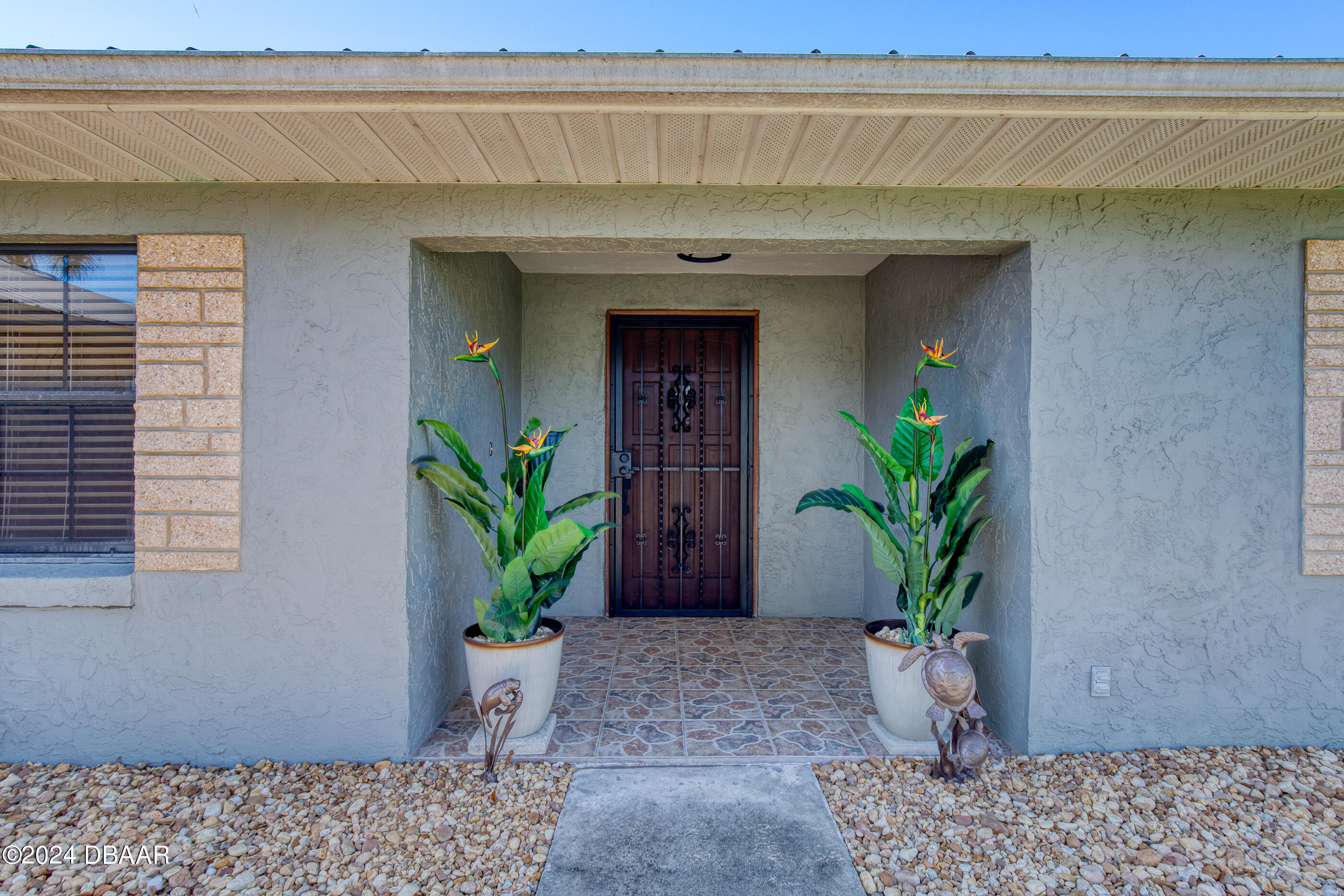 2304 Yule Tree Drive Edgewater, FL 32141 - Photo 7 of 34 a potted plant in front of a door