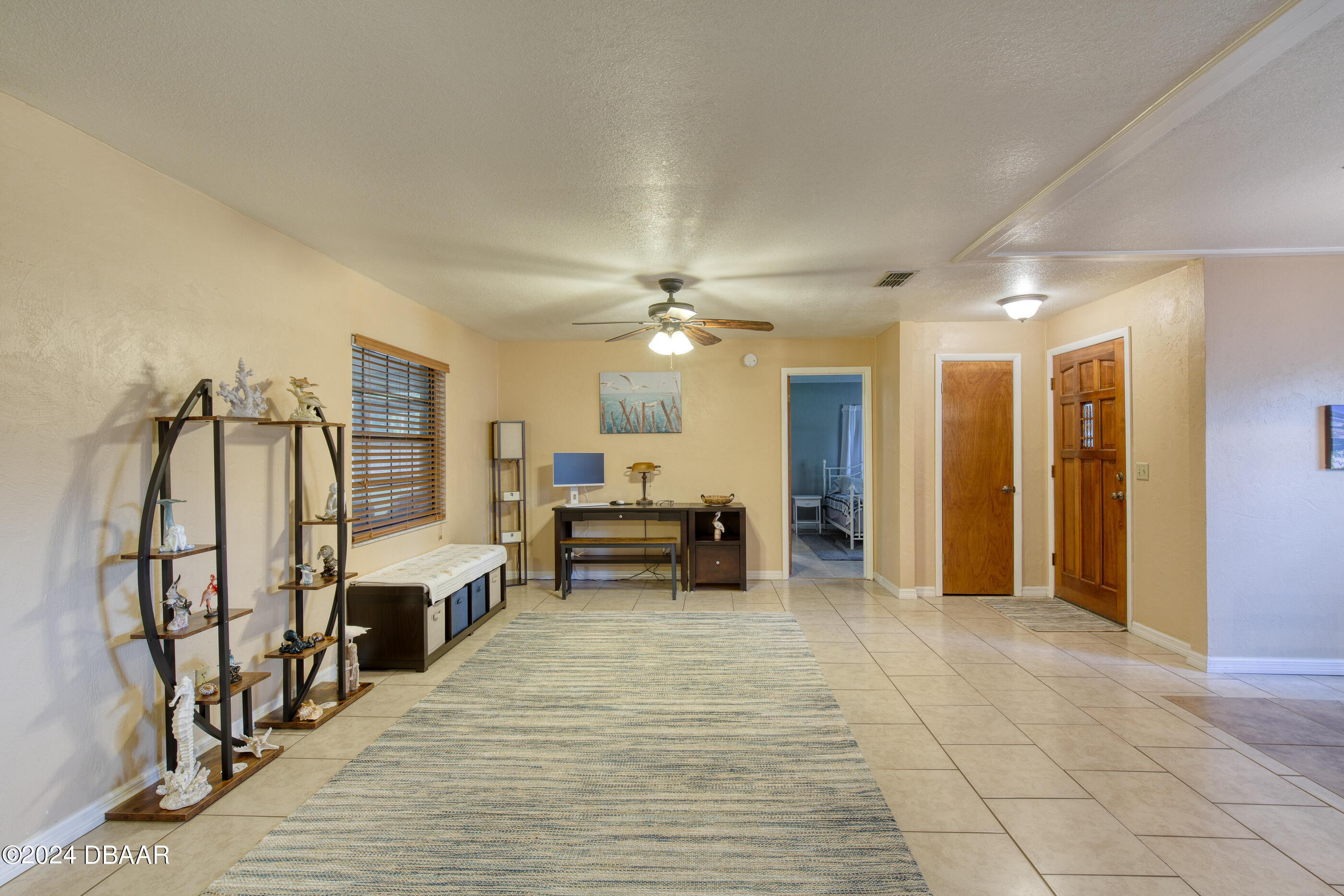 2304 Yule Tree Drive Edgewater, FL 32141 - Photo 8 of 34 a view of a livingroom with furniture and a ceiling fan