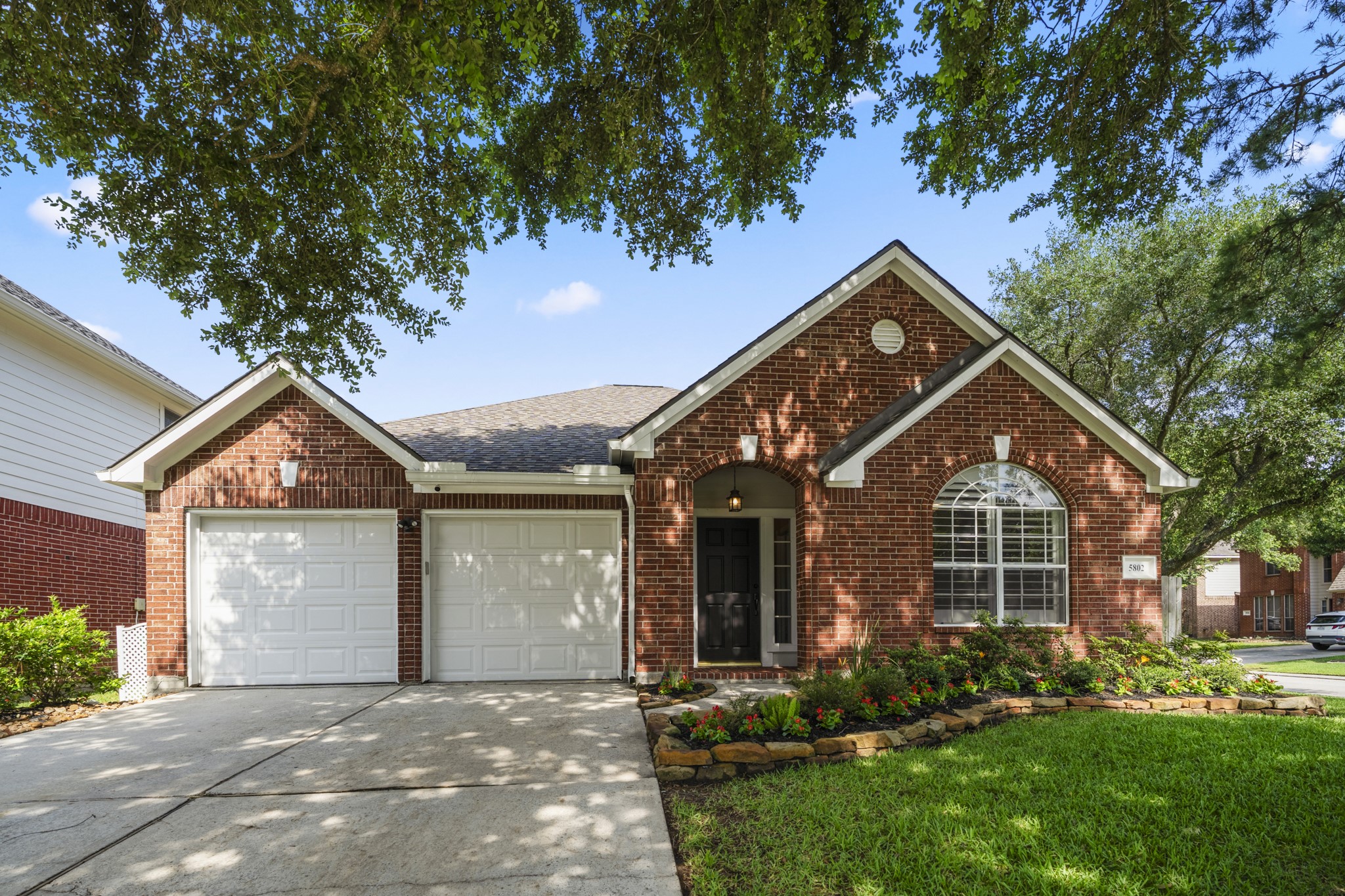 front view of a house with a tree in a yard
