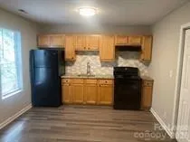 a kitchen with a refrigerator and a stove