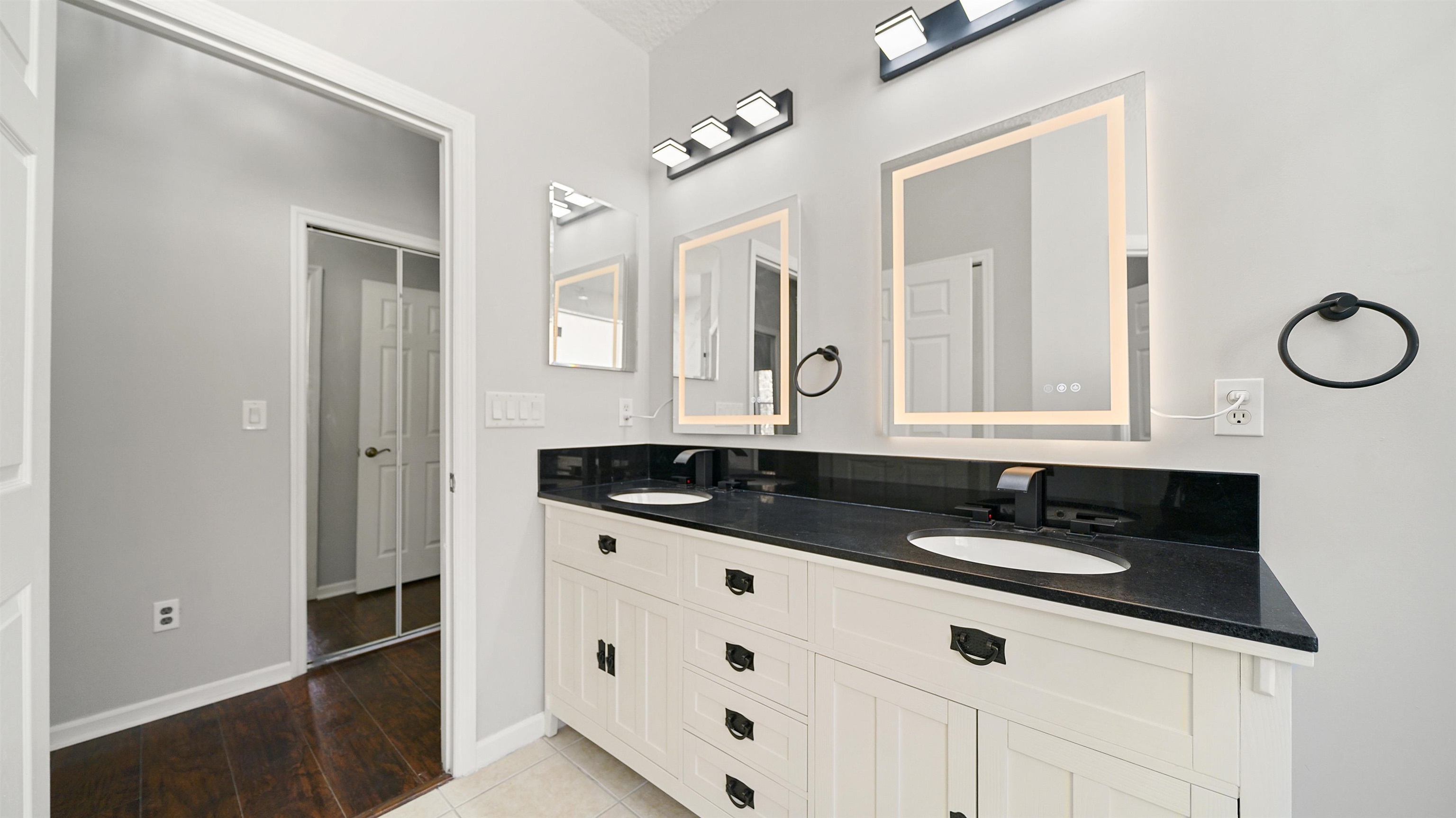 778 Copperhead Circle St. Augustine, FL 32092 - Photo 16 of 35 a bathroom with a granite countertop sink and a mirror