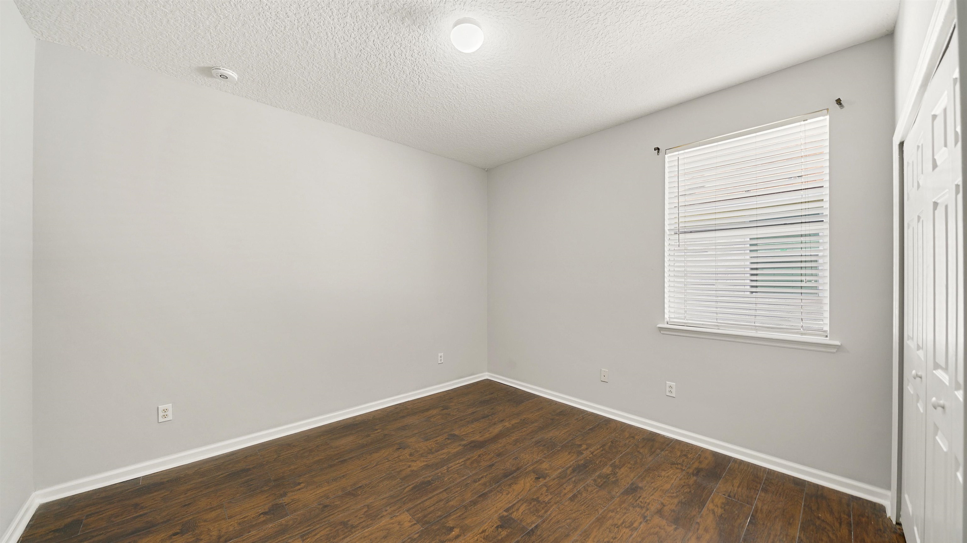 778 Copperhead Circle St. Augustine, FL 32092 - Photo 17 of 35 an empty room with wooden floor and windows
