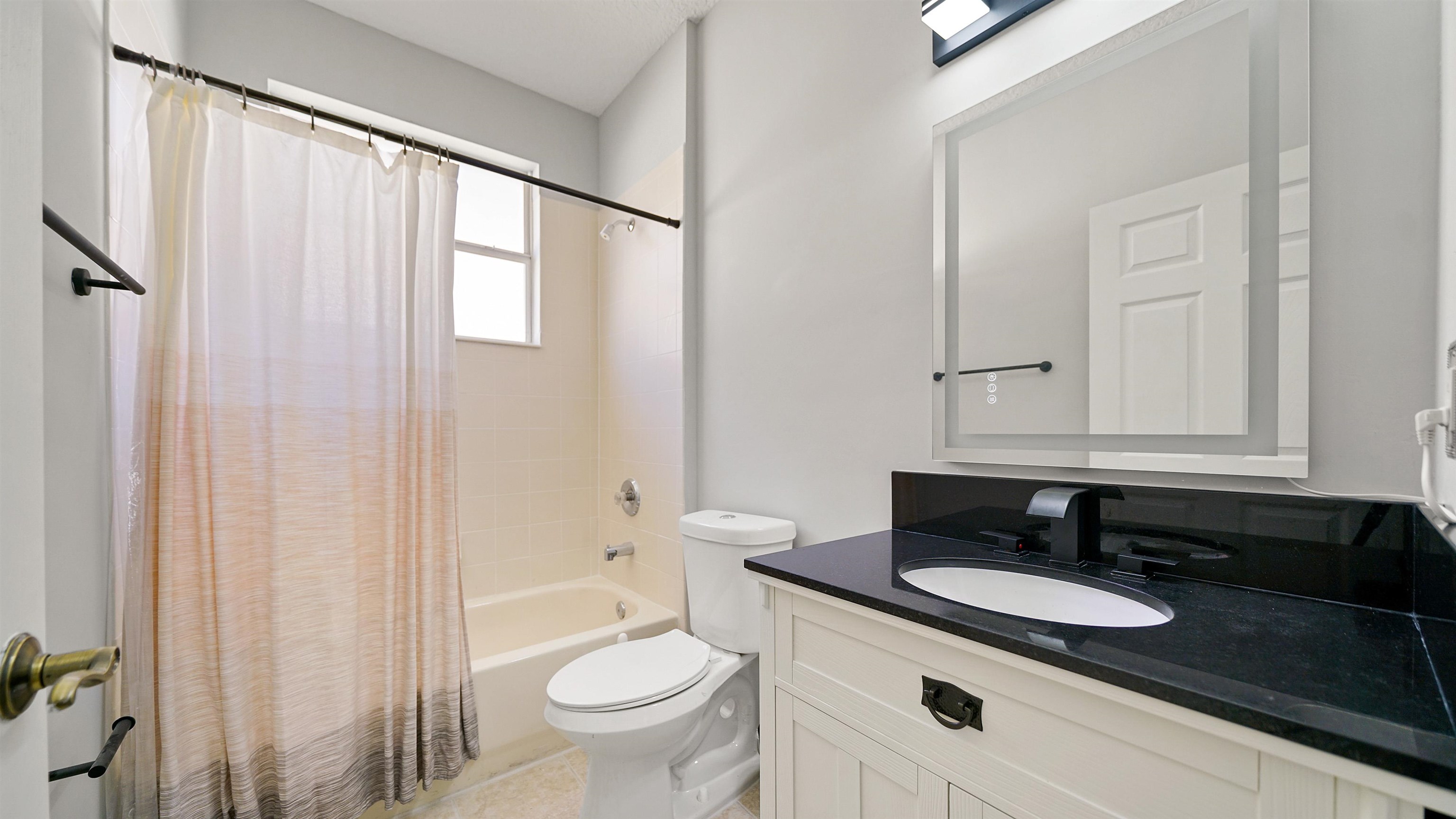 778 Copperhead Circle St. Augustine, FL 32092 - Photo 18 of 35 a bathroom with a granite countertop sink and a mirror