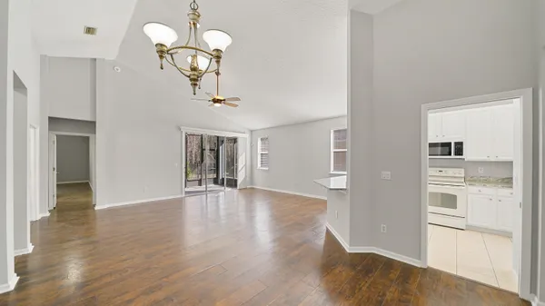 a view of a kitchen with wooden floor and a chandelier