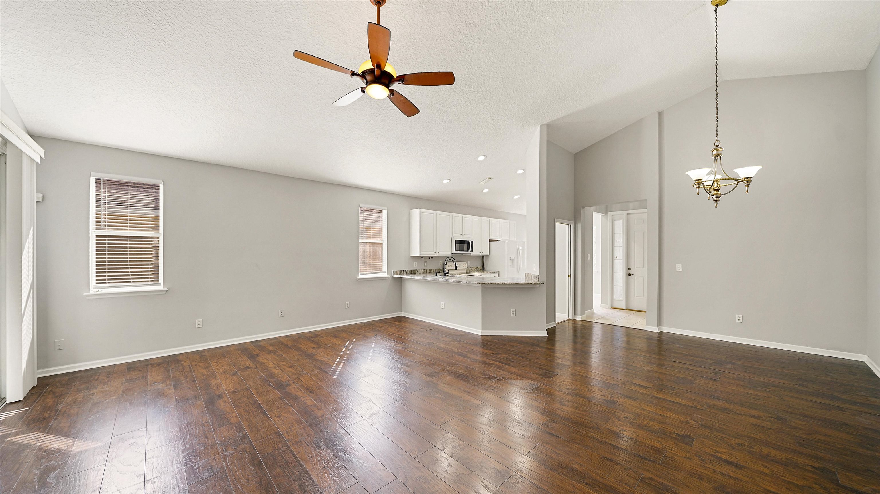 778 Copperhead Circle St. Augustine, FL 32092 - Photo 5 of 35 a view of a kitchen with wooden floor and a ceiling fan