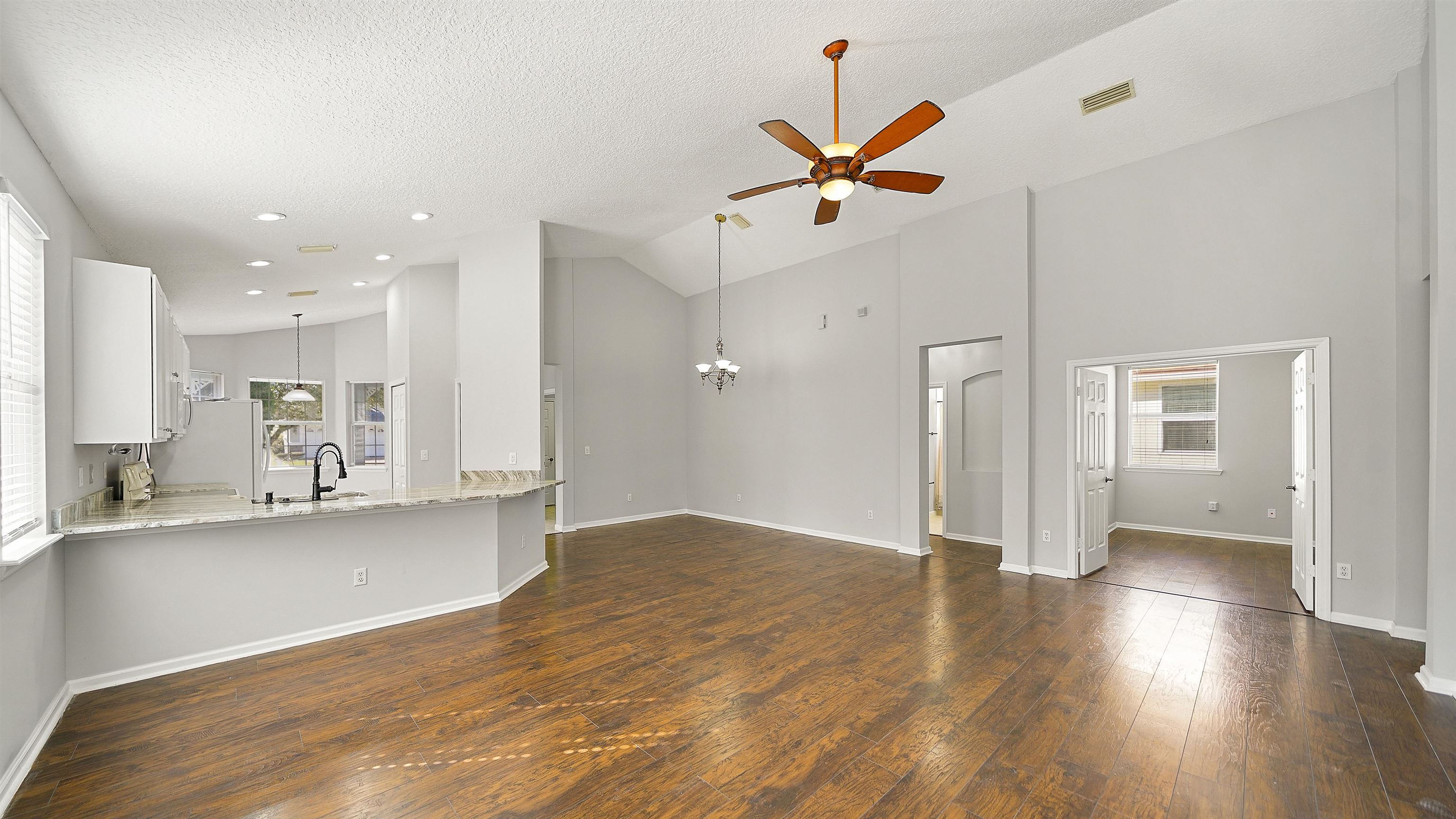 778 Copperhead Circle St. Augustine, FL 32092 - Photo 6 of 35 a view of a kitchen with wooden floor and a sink