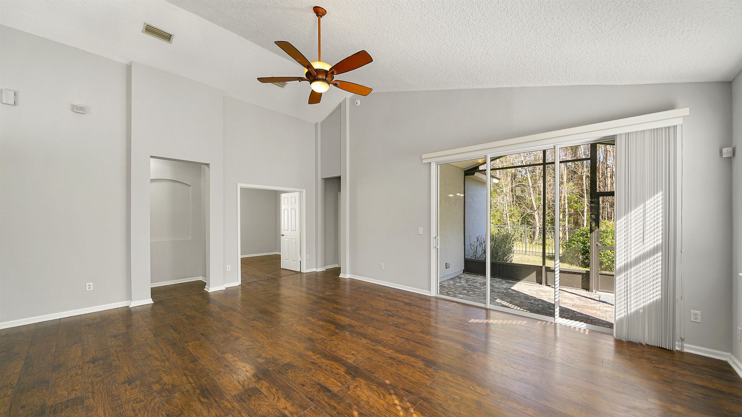 778 Copperhead Circle St. Augustine, FL 32092 - Photo 7 of 35 a view of an empty room with wooden floor and a window