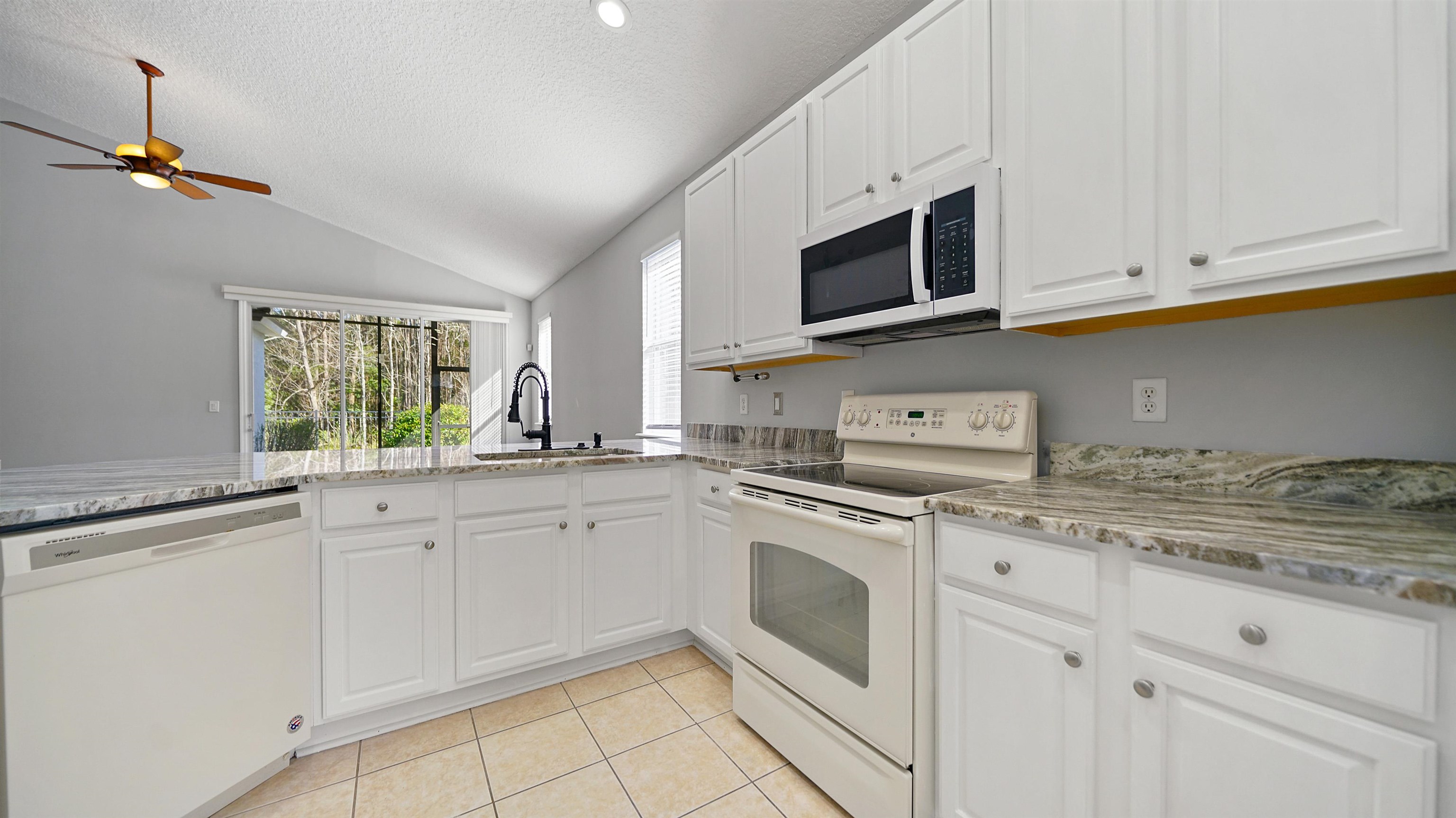 778 Copperhead Circle St. Augustine, FL 32092 - Photo 8 of 35 a kitchen with granite countertop white cabinets stainless steel appliances and a sink