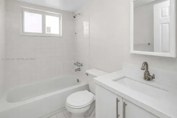 a bathroom with a sink toilet and bathtub
