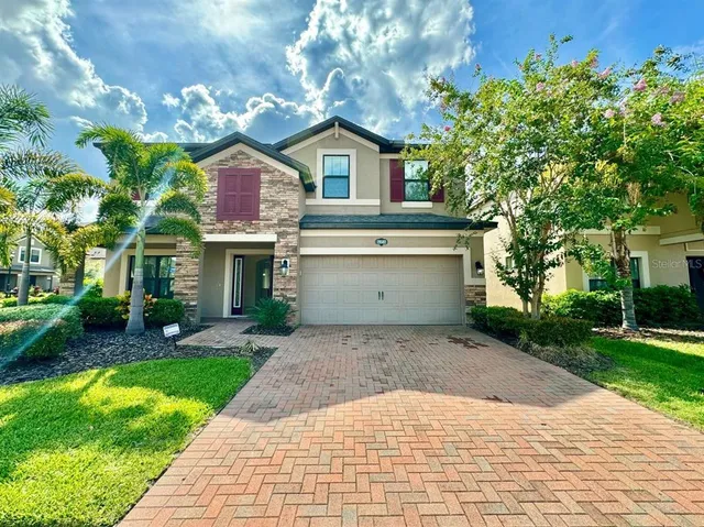 a front view of house with yard and trees